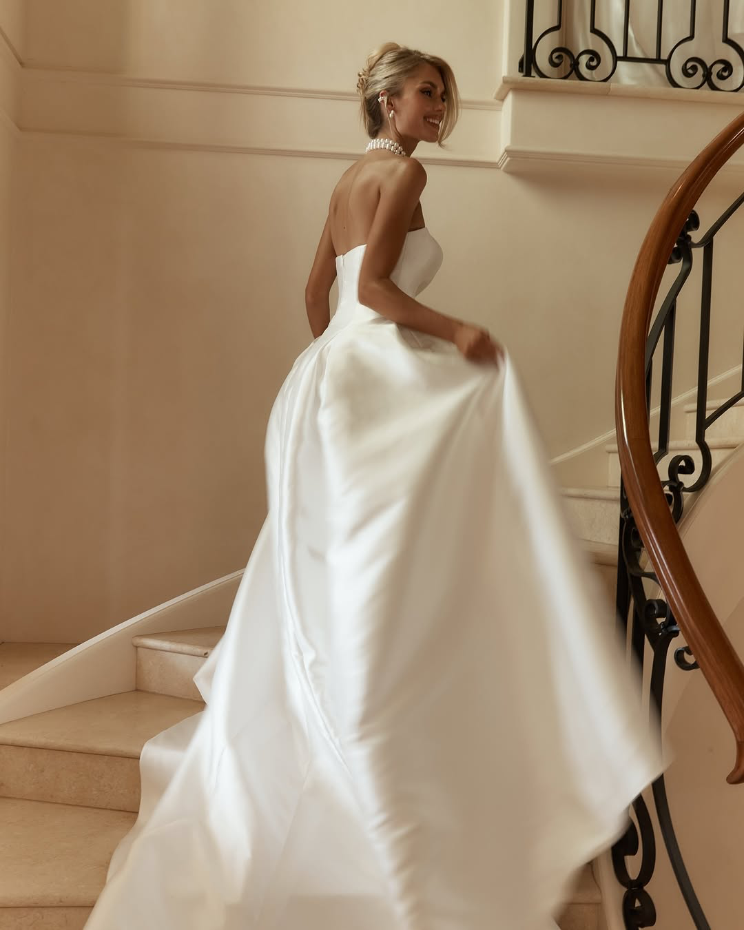 Jane Hill Bridal Dolce redefines regal with a sculptural rounded neckline and a seamless, panelled bodice that melts into the skirt. designed to elongate the figure, this minimalist silhouette features a hidden back zip for a clean finish.