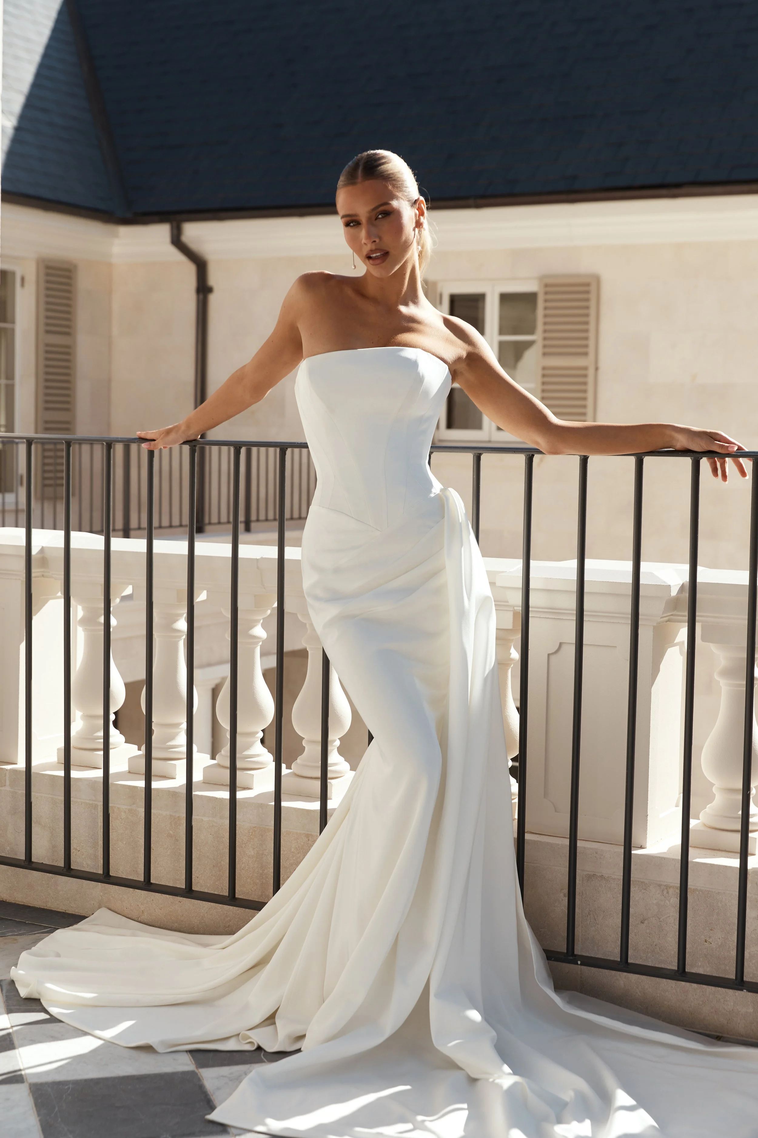 Jane Hill Bridal Slate; Modern, sculpted and effortlessly refined, Slate is a contemporary take on classic corsetry. The straight neckline and exposed seam detailing highlight the structured bodice, flowing into a basque waist that shapes and elongat