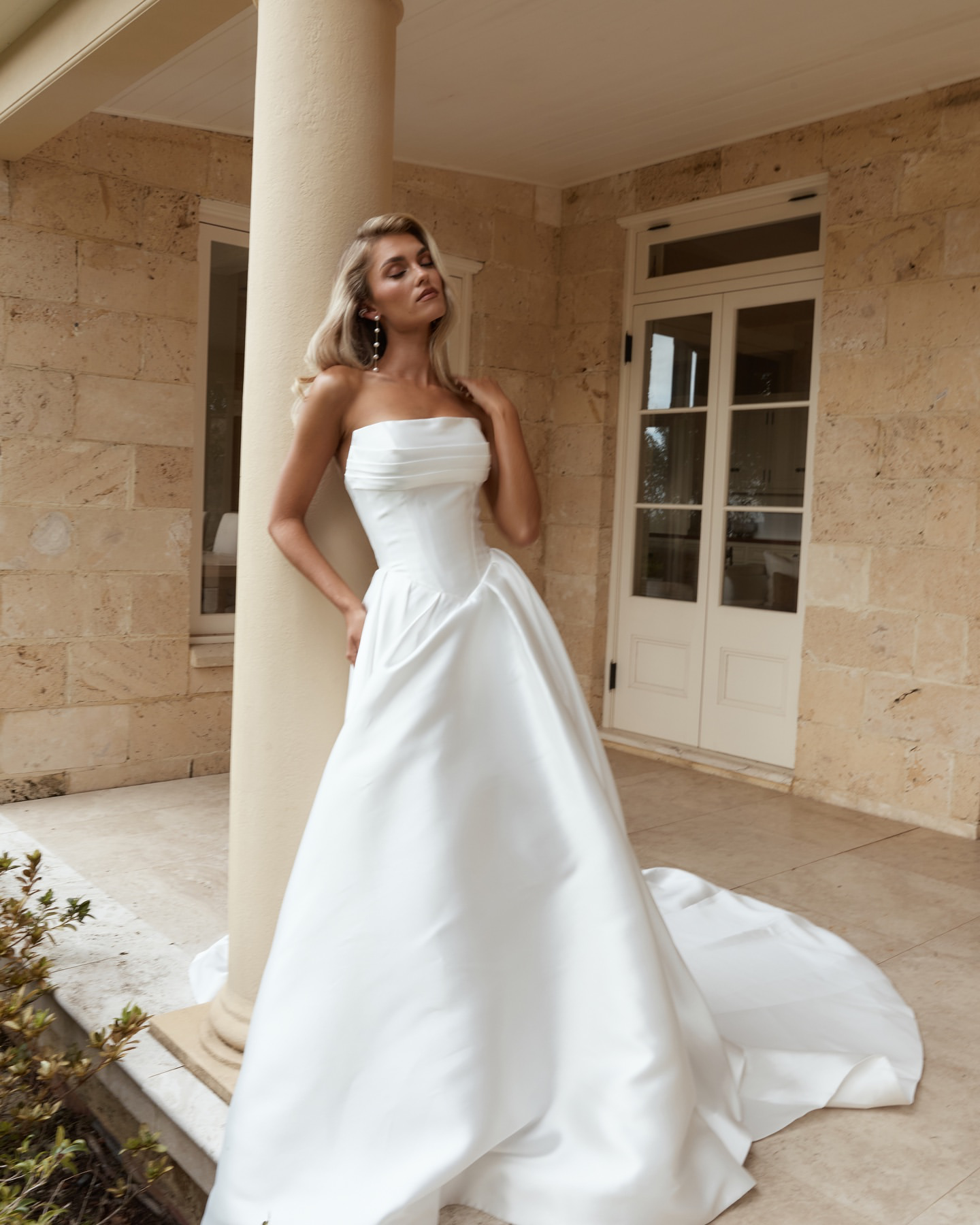 Jane Hill Bridal Anderson timeless meets modernity in Anderson. with a flattering elongated v-shaped corset and clean straight neckline, this gown is finished with our voluminous signature skirt in luxe mikado
