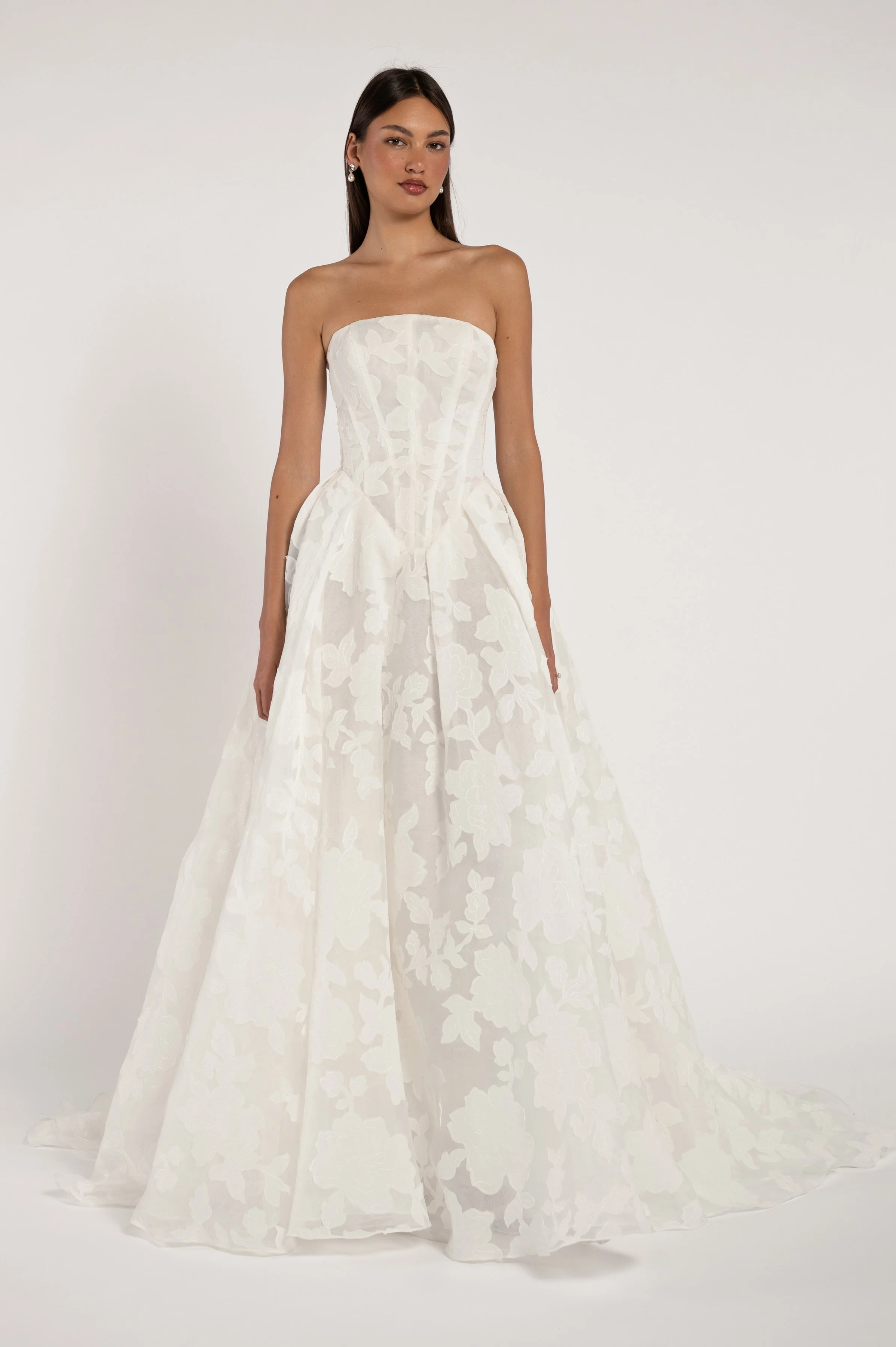 Jenny Yoo The Alva gown marries a modern corset bodice with a dramatically romantic floral motif. The overall effect being one that is strikingly timeless. Available at Halo & Wren