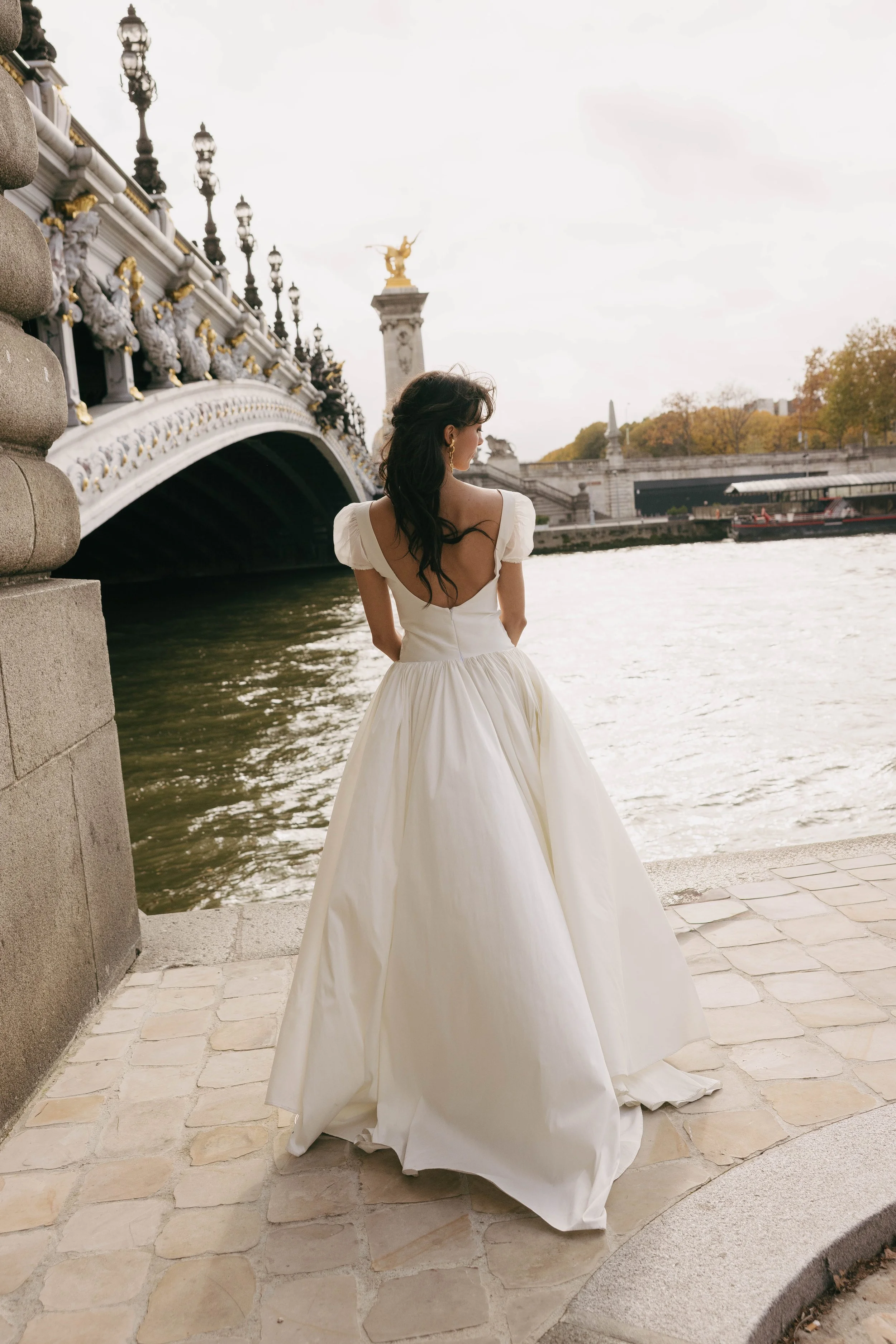 The & For Love Bridal Degas gown is a cool, fashion-forward bridal statement designed to redefine modern wedding style. With its sleek silhouette, avant-garde detailing, and elevated design edge, this gown delivers contemporary attitude without sacri