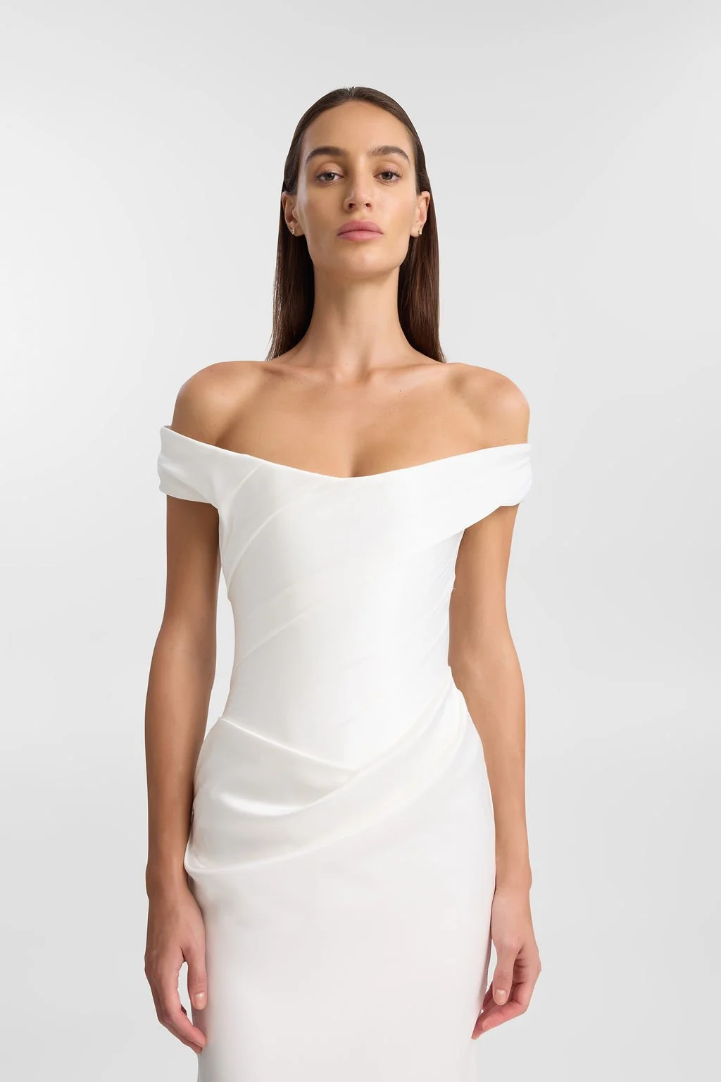 Irreverent glamour takes the spotlight in KYHA Bride Nia. Cut from sleek double satin, Nia features a highly structured bodice with a tight drape and a fit-and-flare skirt cut to accentuate the silhouette. The draping graciously falls into a floor-sw