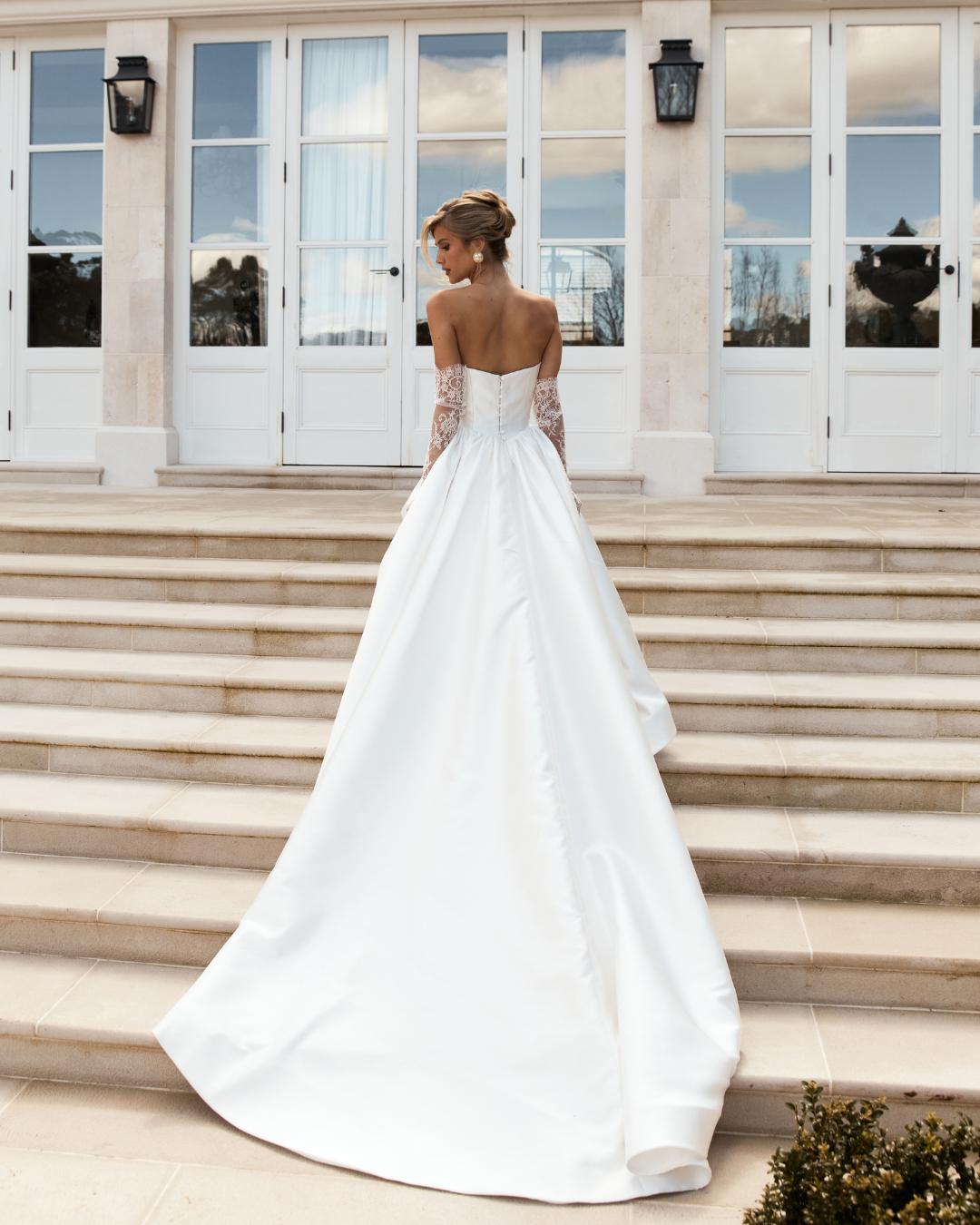 A timeless statement with a touch of couture romance, Jane Hill Bridal Audrey pairs a beautifully structured bodice with delicate lace trim that softens the strapless neckline. The full mikado skirt is truly one-of-a-kind—voluminous yet refined—with 
