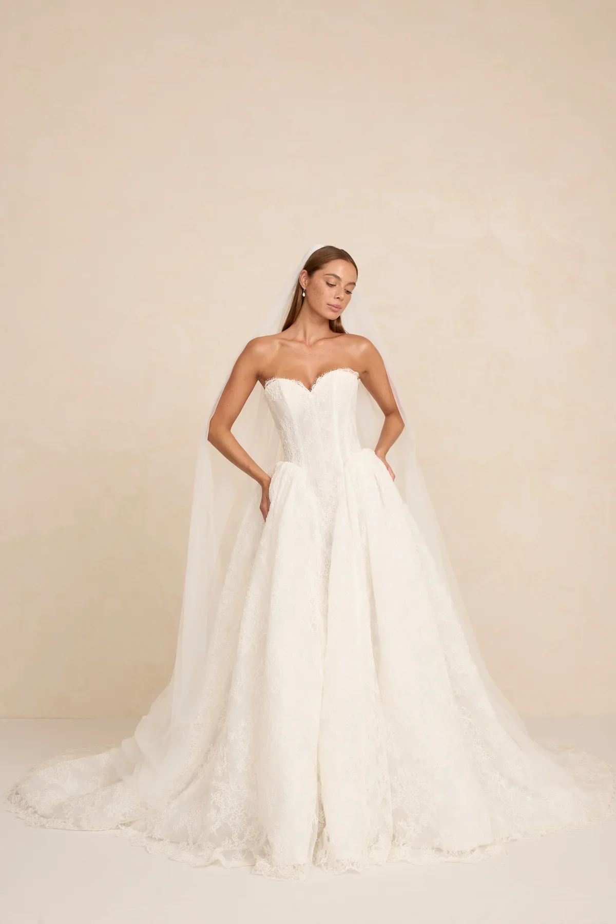 The MWL Rue is a modern bridal masterpiece in delicate Chantilly lace with matching trim at the neckline. Structured boning and a sweetheart neckline create a sculpted, feminine silhouette. Available at Halo & Wren Bridal mid June 2026.
