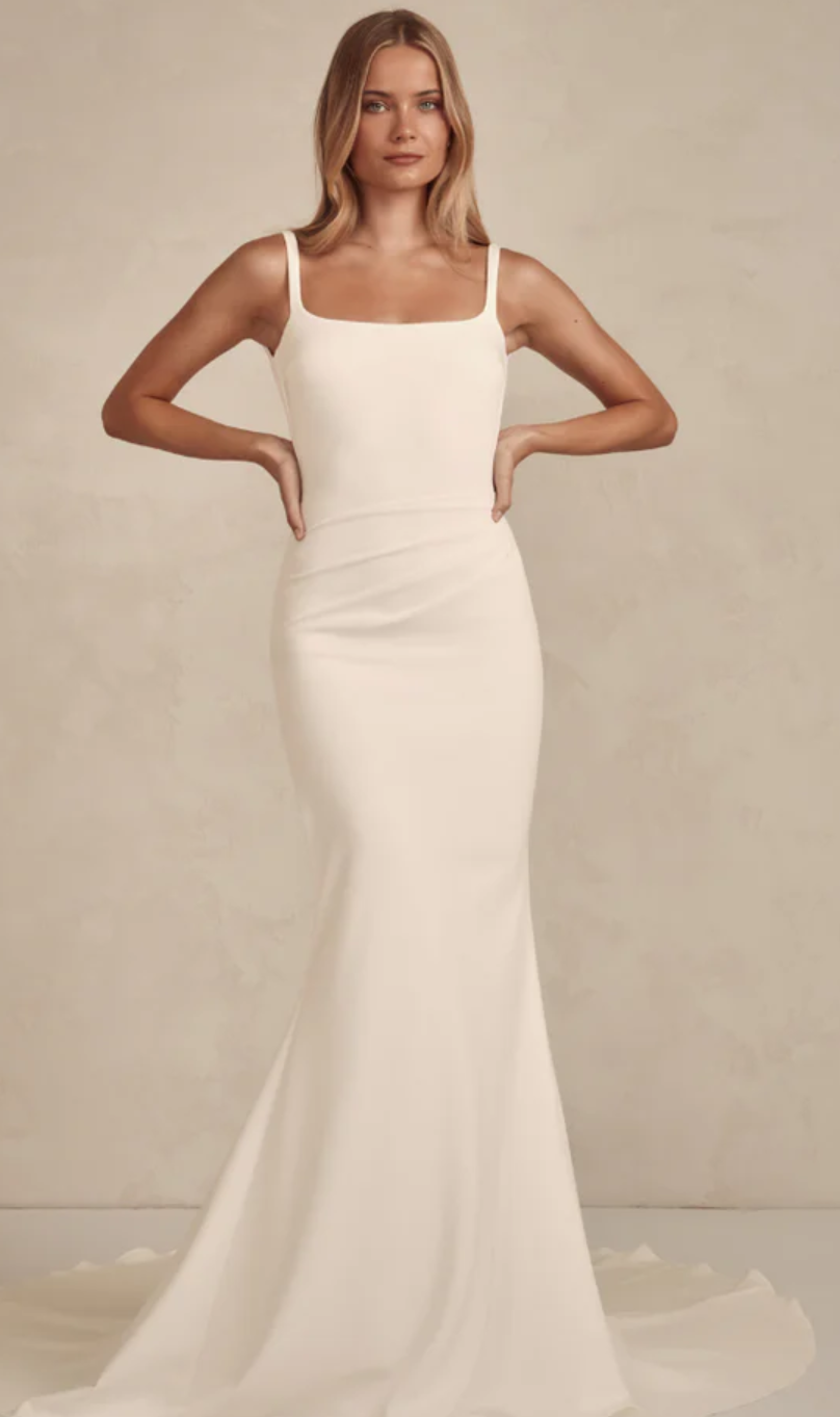 MWL Bridal Gracie is the embodiment of quiet luxury and modern minimalism. Crafted from our luxurious French Crepe, her subtle square neckline and delicate straps frame the shoulders with effortless grace. The silhouette is softly sculpted, with cons