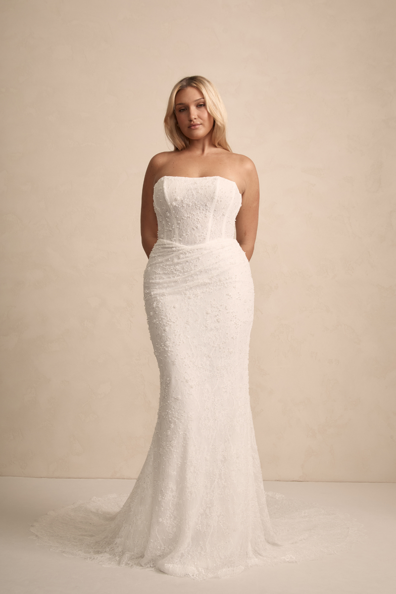 MWL Haven is made from the finest beaded Chantilly lace, with intricate eyelash lace trim details adorning the hem, adding a touch of elegance to her timeless design. Her corset back, complete with pearl-beaded ties, offers a perfect balance of detai