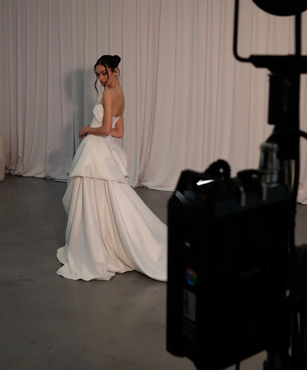 KYHA Bride Preston: an ode to eras past. A fresh take on tradition, Preston brings a modern edge thanks to its structural draping, showstopping train and architectural dropped waist. Crafted from luxe silk satin, Preston’s strapless silhouette, struc