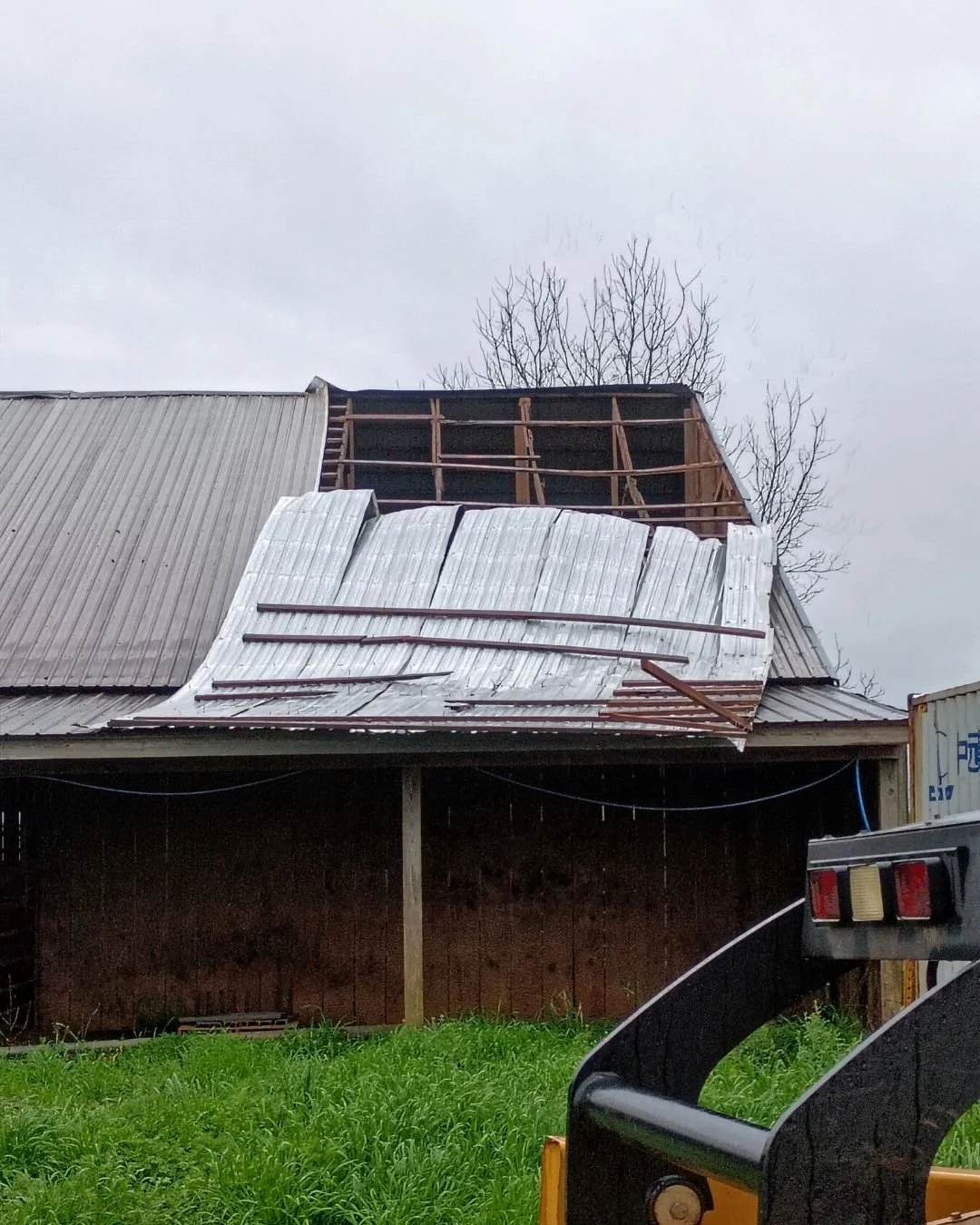 folded roof damage on the barn.jpg