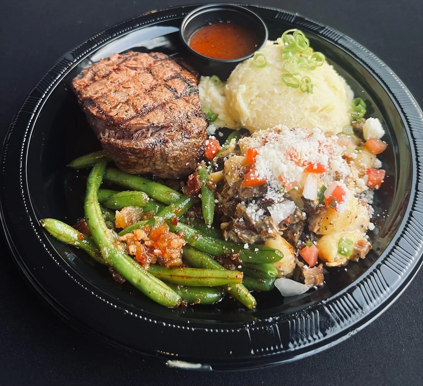 Dinner plate of steak, fresh green beans and mashed potatoes at an event by Southern Standard.