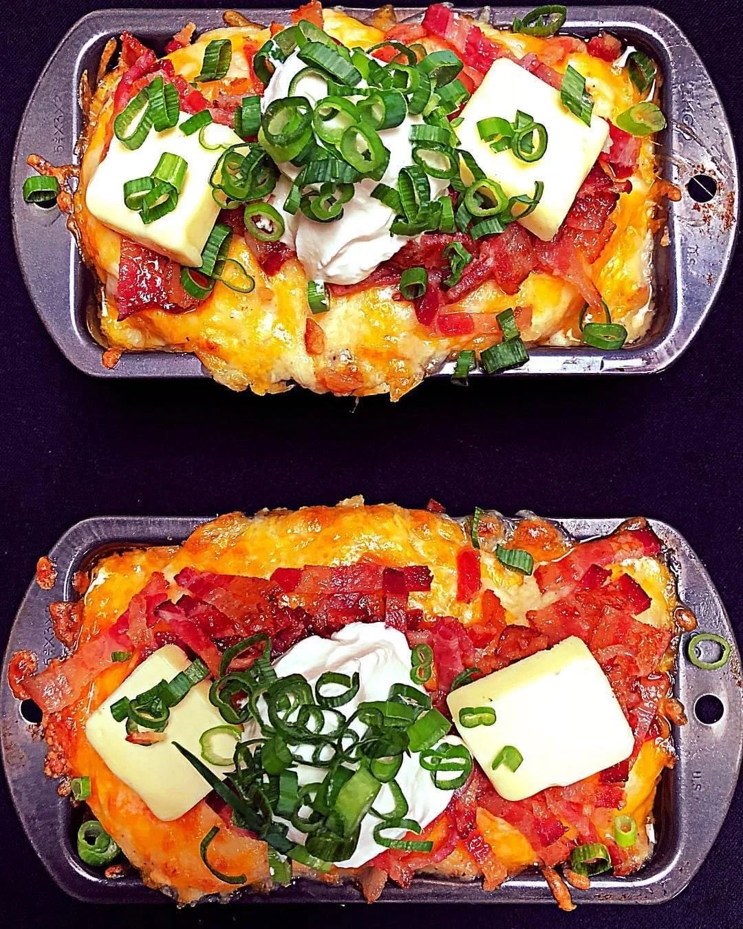 Loaded twice-baked potatoes, topped with crispy bacon, melted cheddar cheese, and fresh green onions. Perfectly crafted by Southern Standard Events & Catering in Houston.