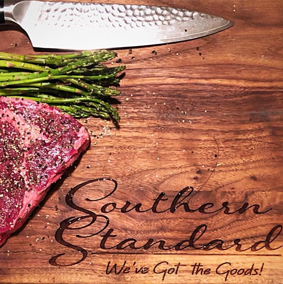 Ready to grill seasoned steak and asparagus prepared by Southern Standard in Houston.