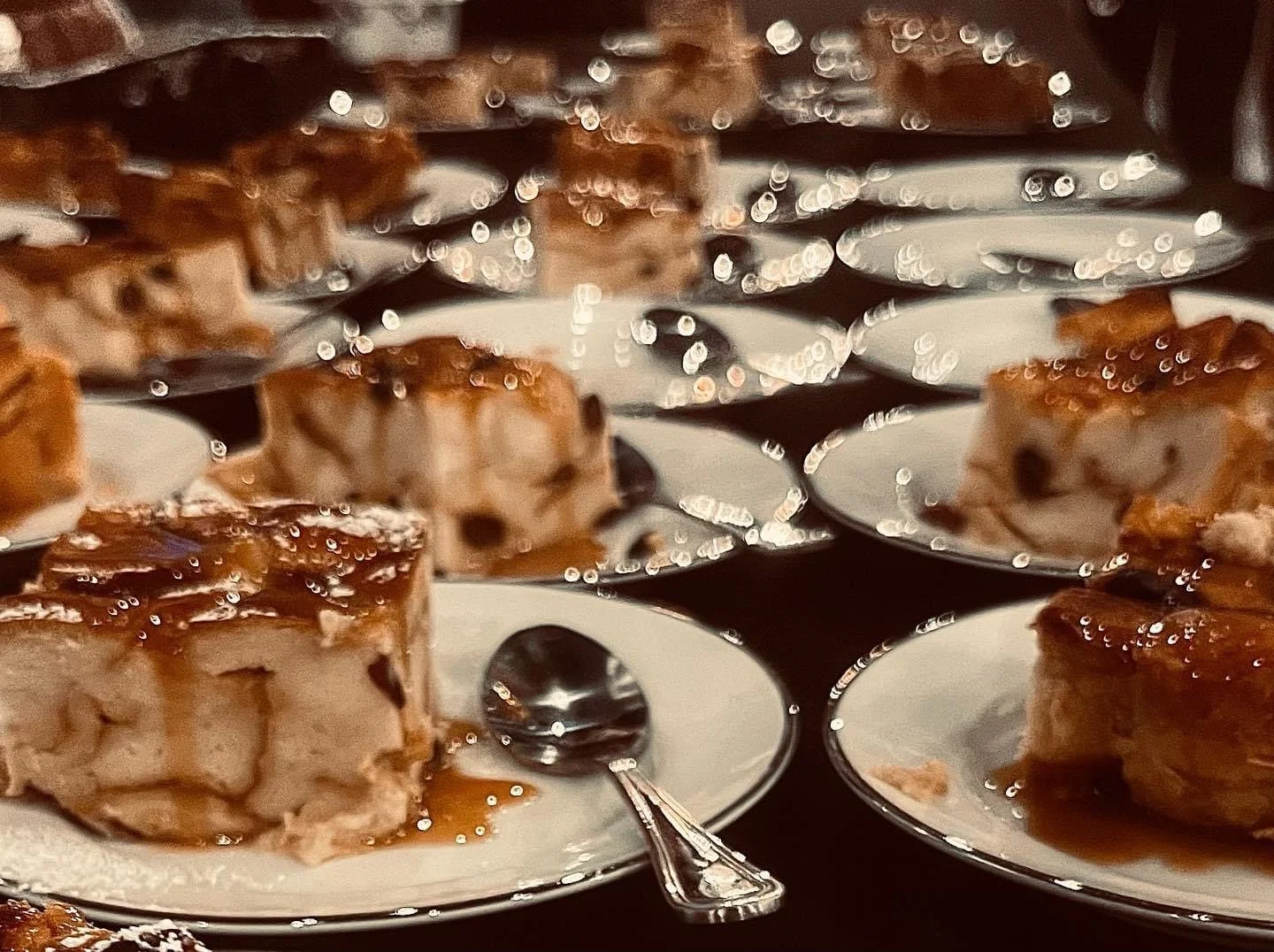 Decadent Bread Pudding Dessert drizzled with a sweet caramel sauce, expertly prepared by Southern Standard Events & Catering in Houston. 