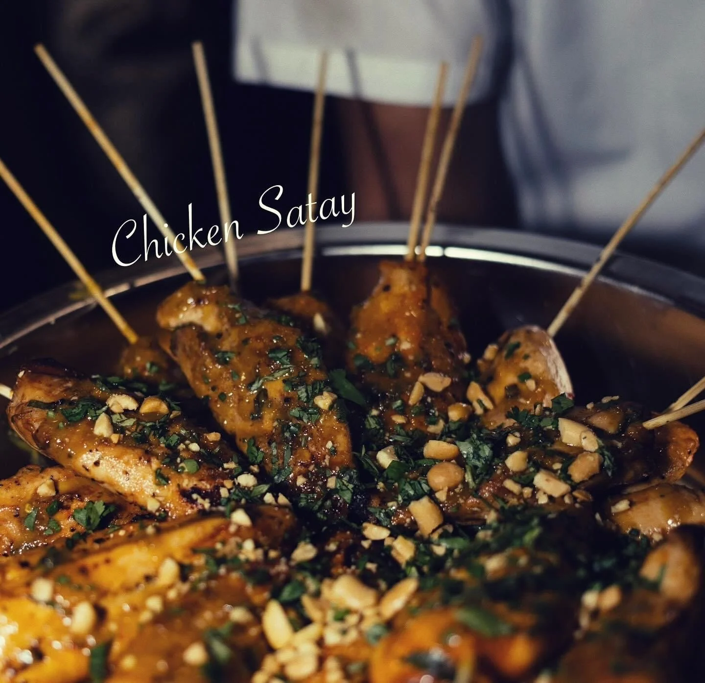 Chicken Satay skewers with tender chicken and rich peanut sauce, elevating any gathering with Southern Standard's catering and event planning.