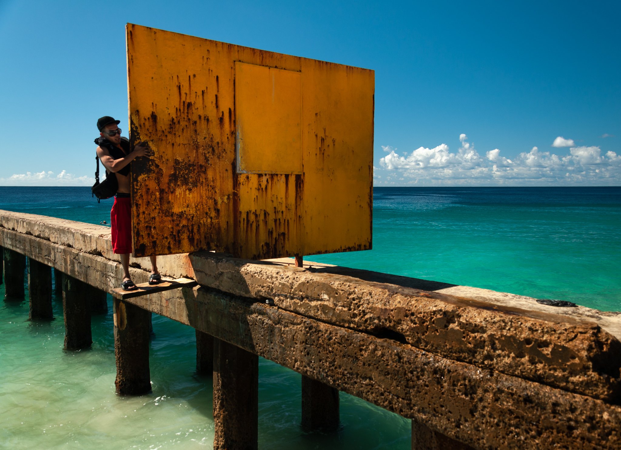 Crash boat baech, I think in Aguadilla, Puerto Rico. It was a lot of fun jumping off the pier. To get where you could jump, you had to walk around the barricade, on the plank like this Gentleman.