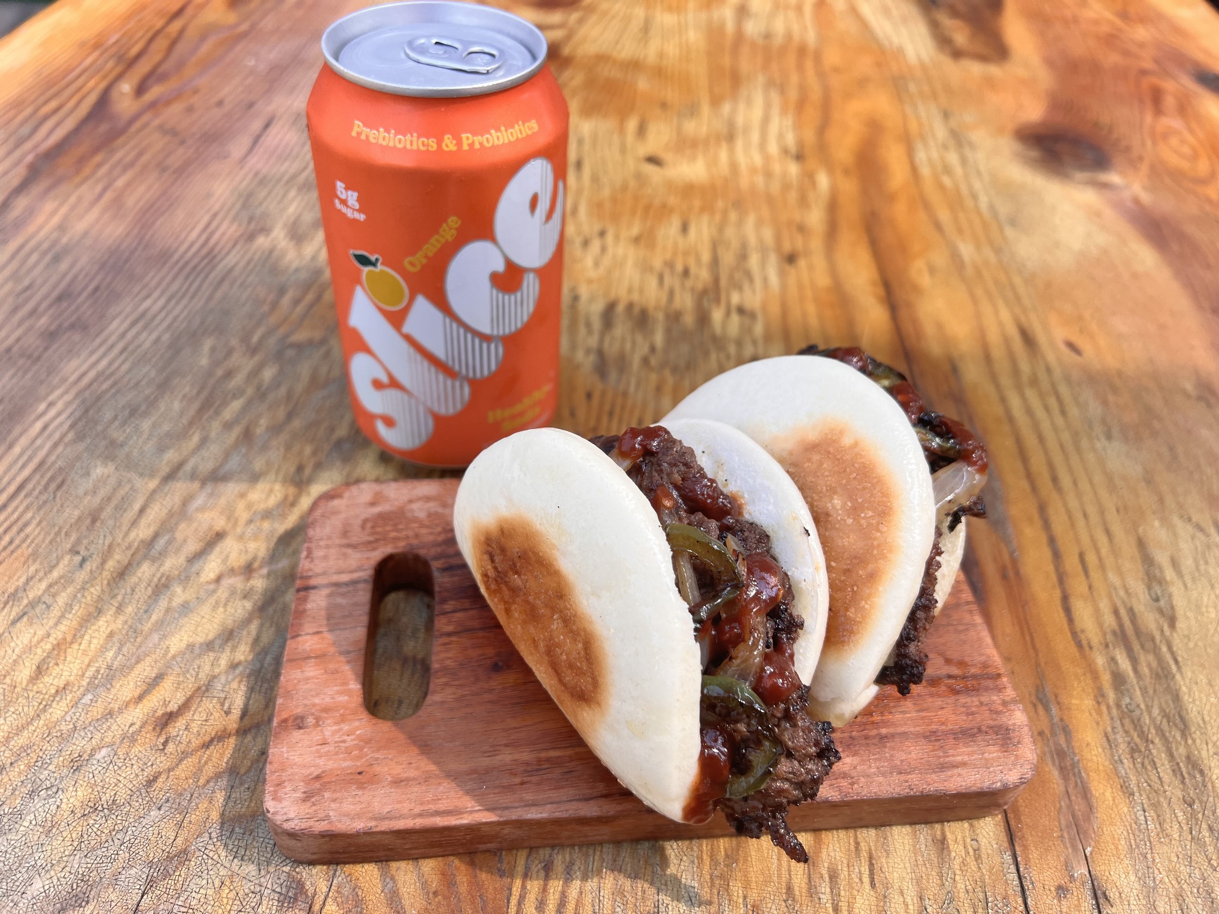 ILUB x KennyHoopla
Smash Bao-ger with grilled onions & jalapenos, topped with spicy BBQ sauce, on a toasted bun.
$12 special item with FREE* Slice soda! (while supplies last, onsite only at SteelCraft LB)