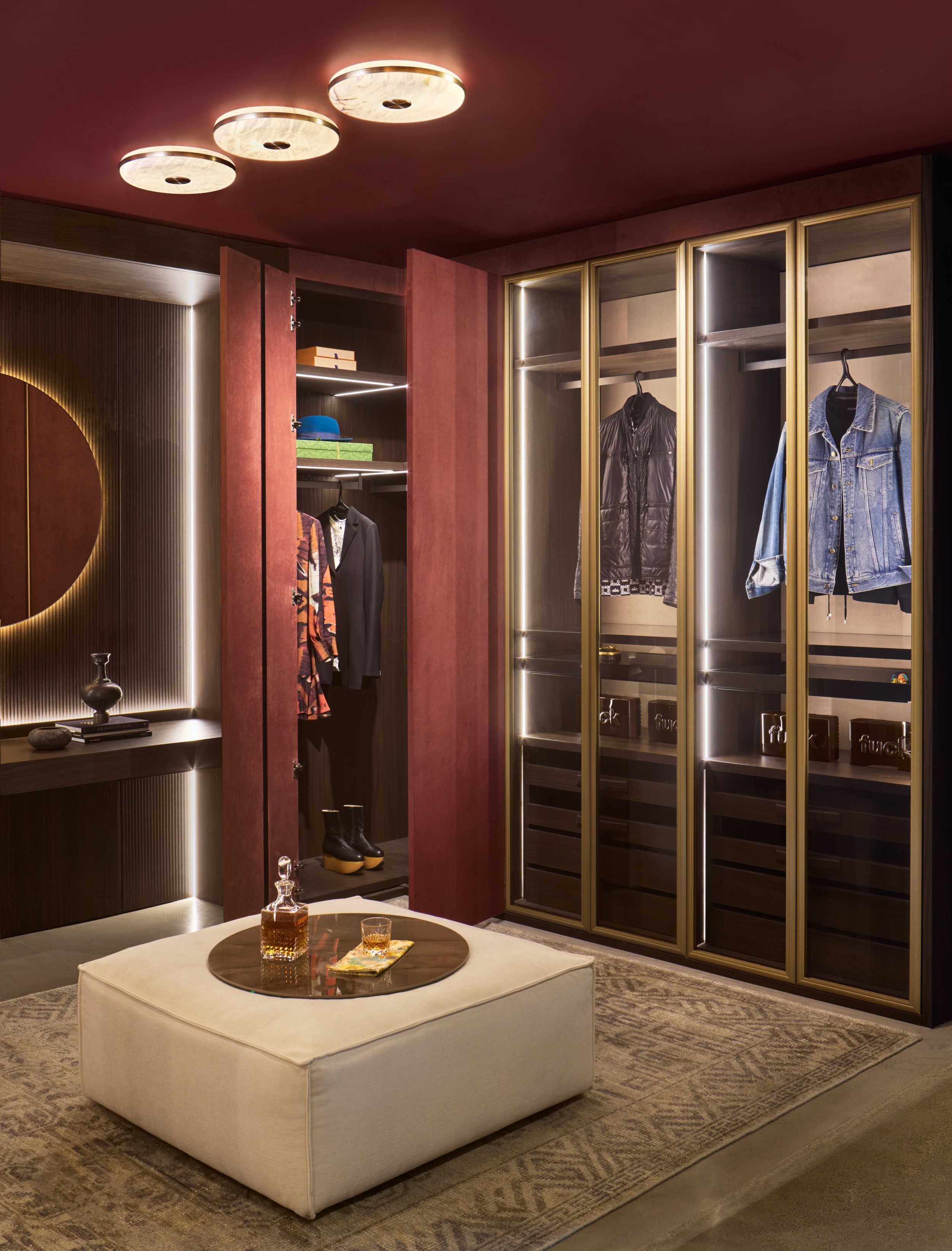 Bronze-framed glass wardrobe cabinets with vertical LED lighting, Alcantara-lined interiors, and leather-handle pull-out glass trays — SCIC Night Collection, San Francisco showroom
