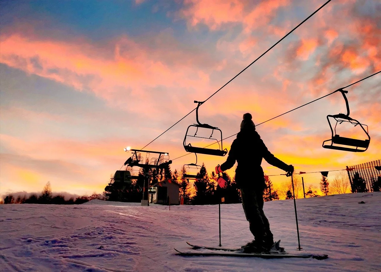 skier watching sunset over hakuba ski fields