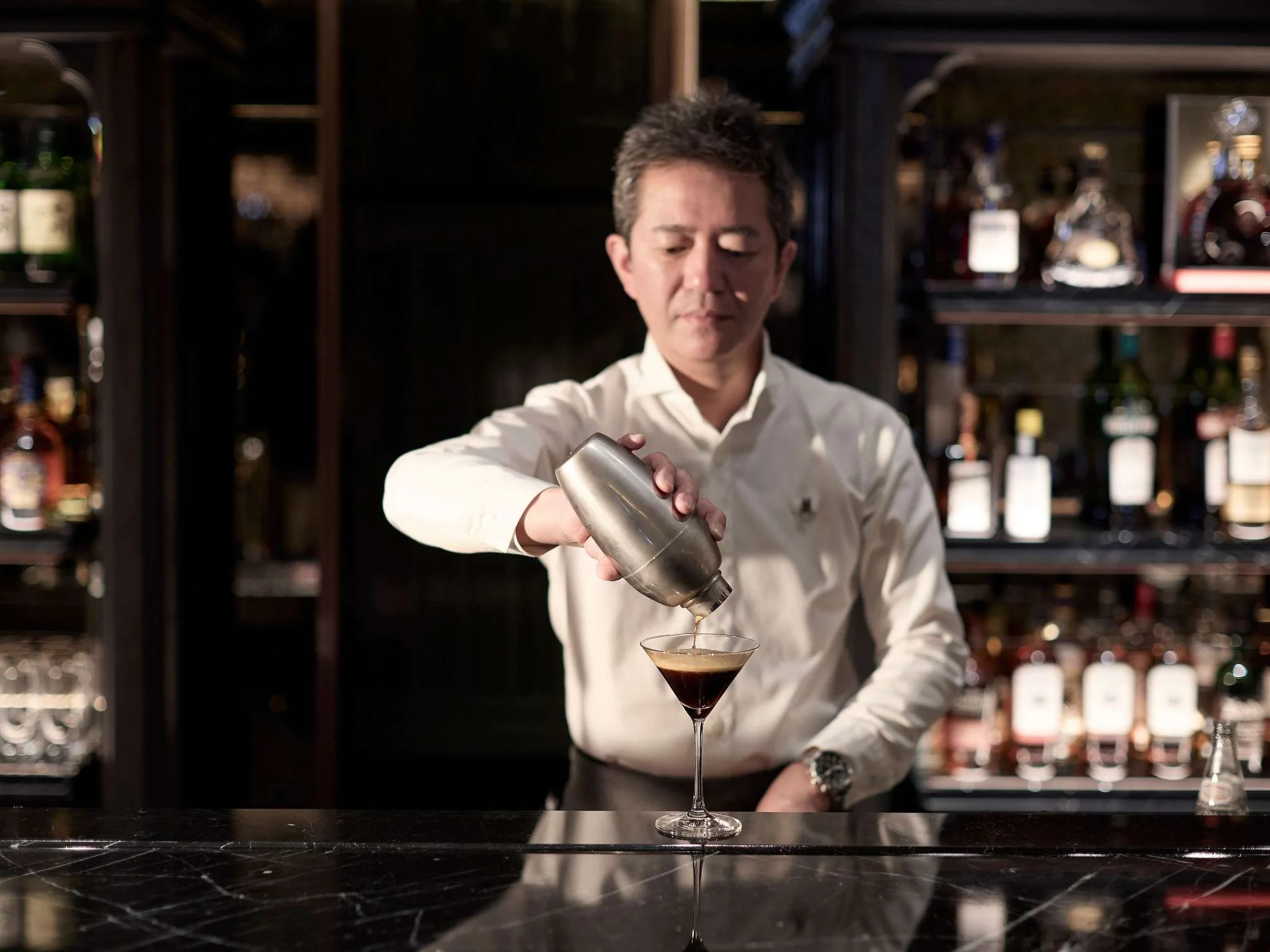 Barman pouring an espresso martini