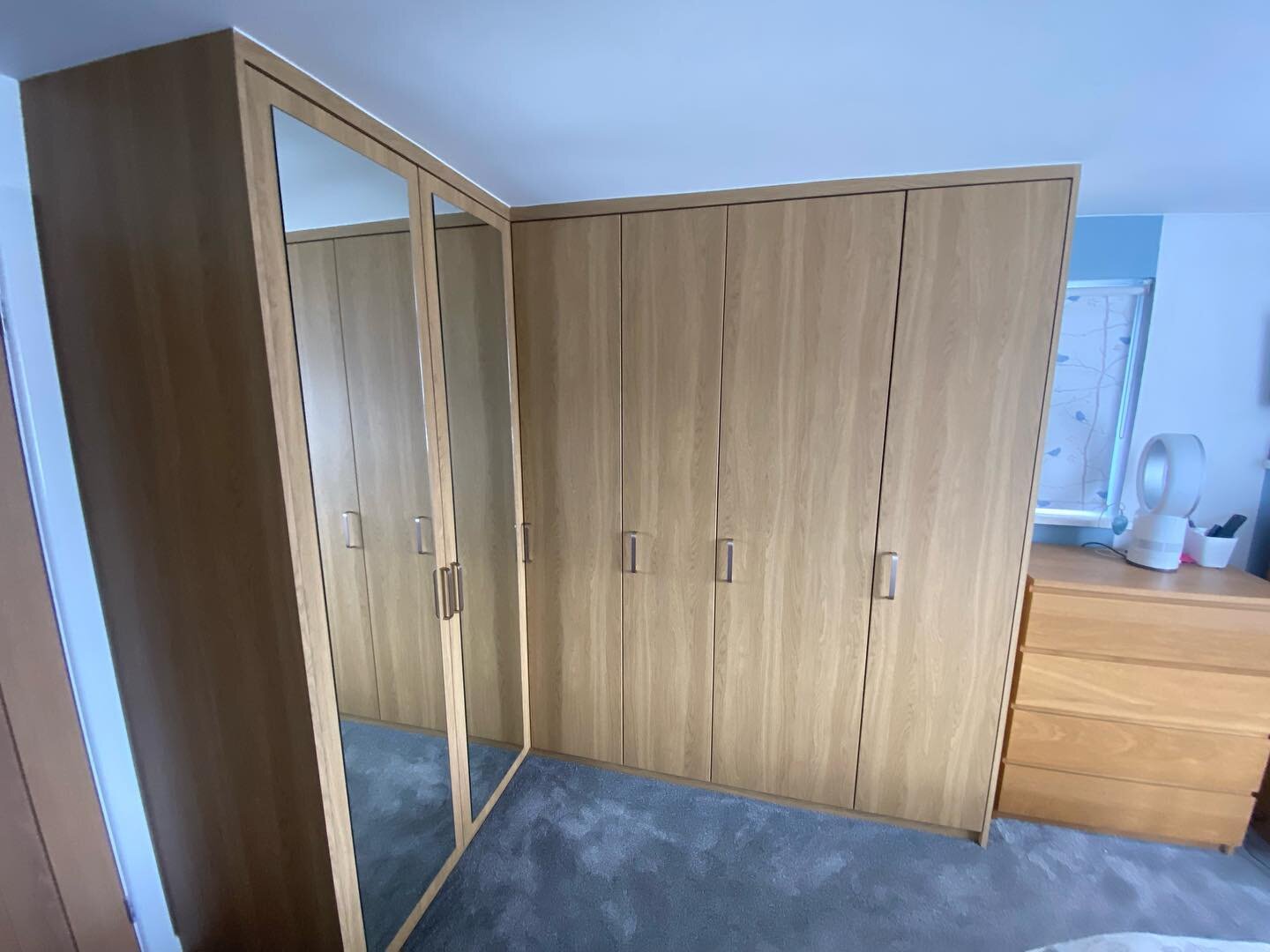 Bespoke corner wardrobes installed. This included multiple hanging rails and concealed draws with soft close runners. Pre finished oak effect materials used to clad the exterior.
