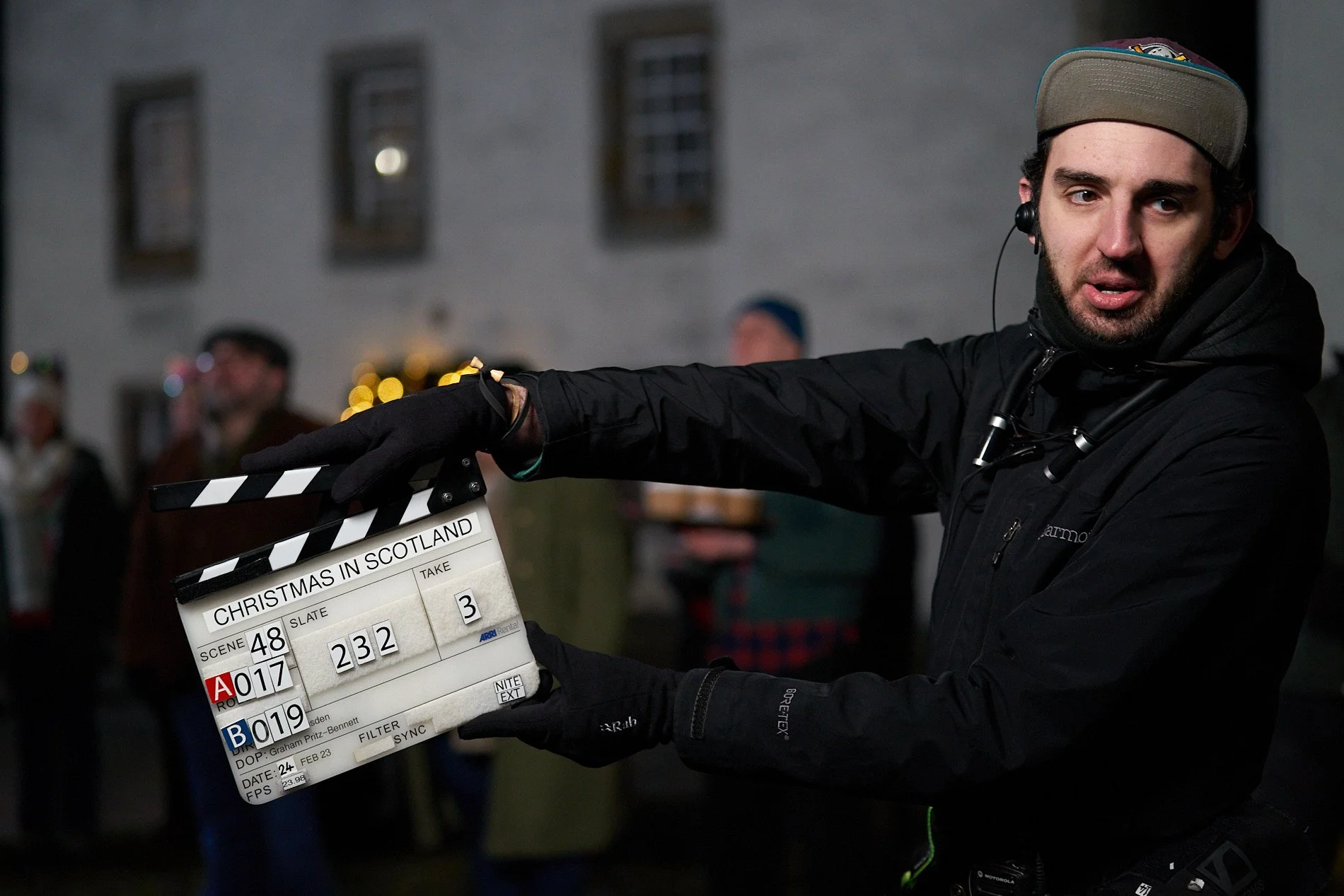 1st AC with a clapper board on the set of a feature film
