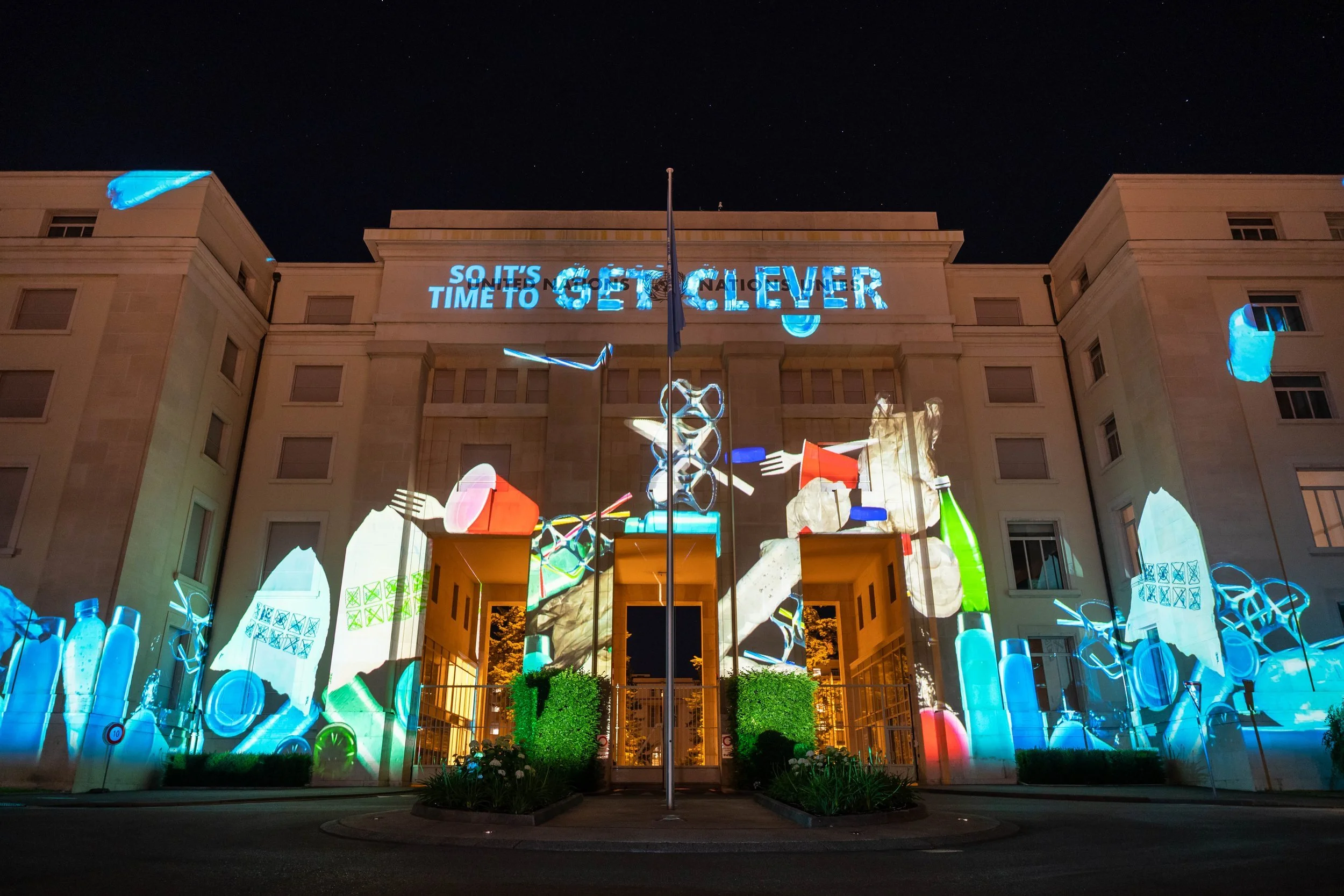 UN building with pieces of plastic projected onto the building - Image taken from Plastic is forever project for the UN produced by Heehaw