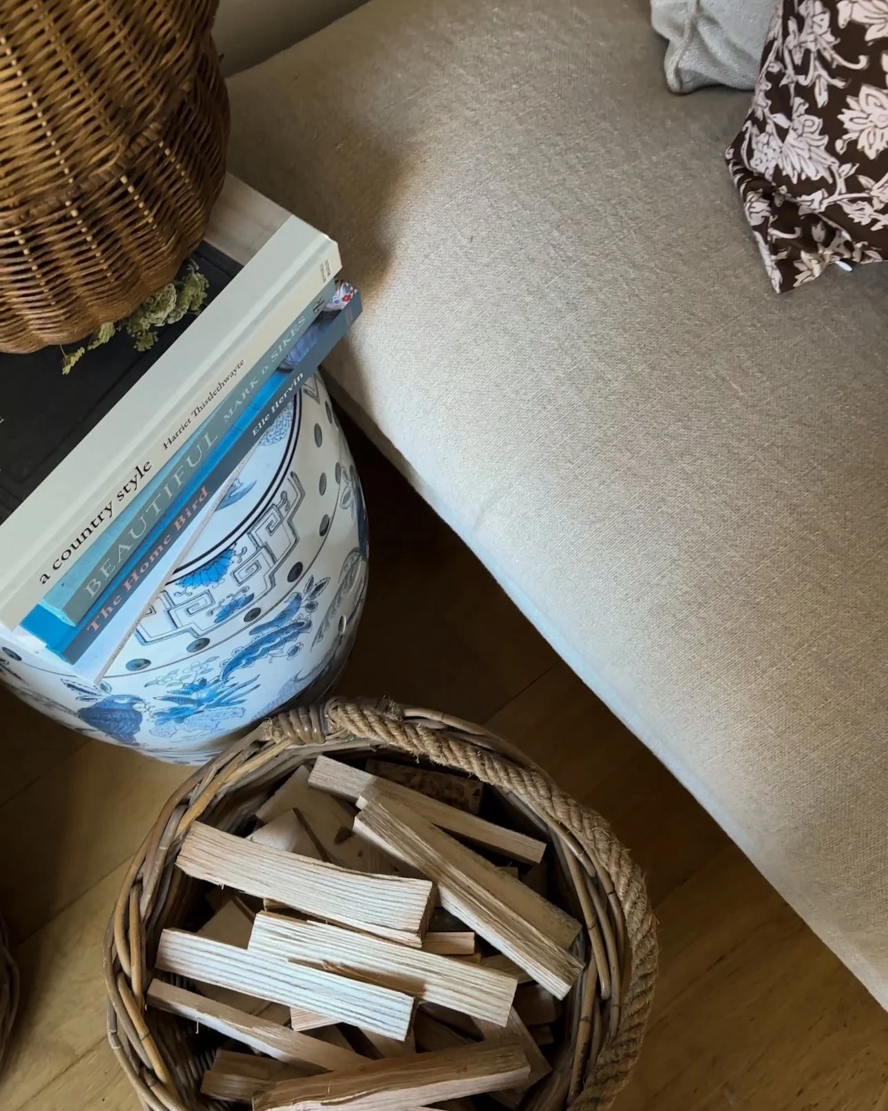 log basket with rope handle filled with chopped kindling