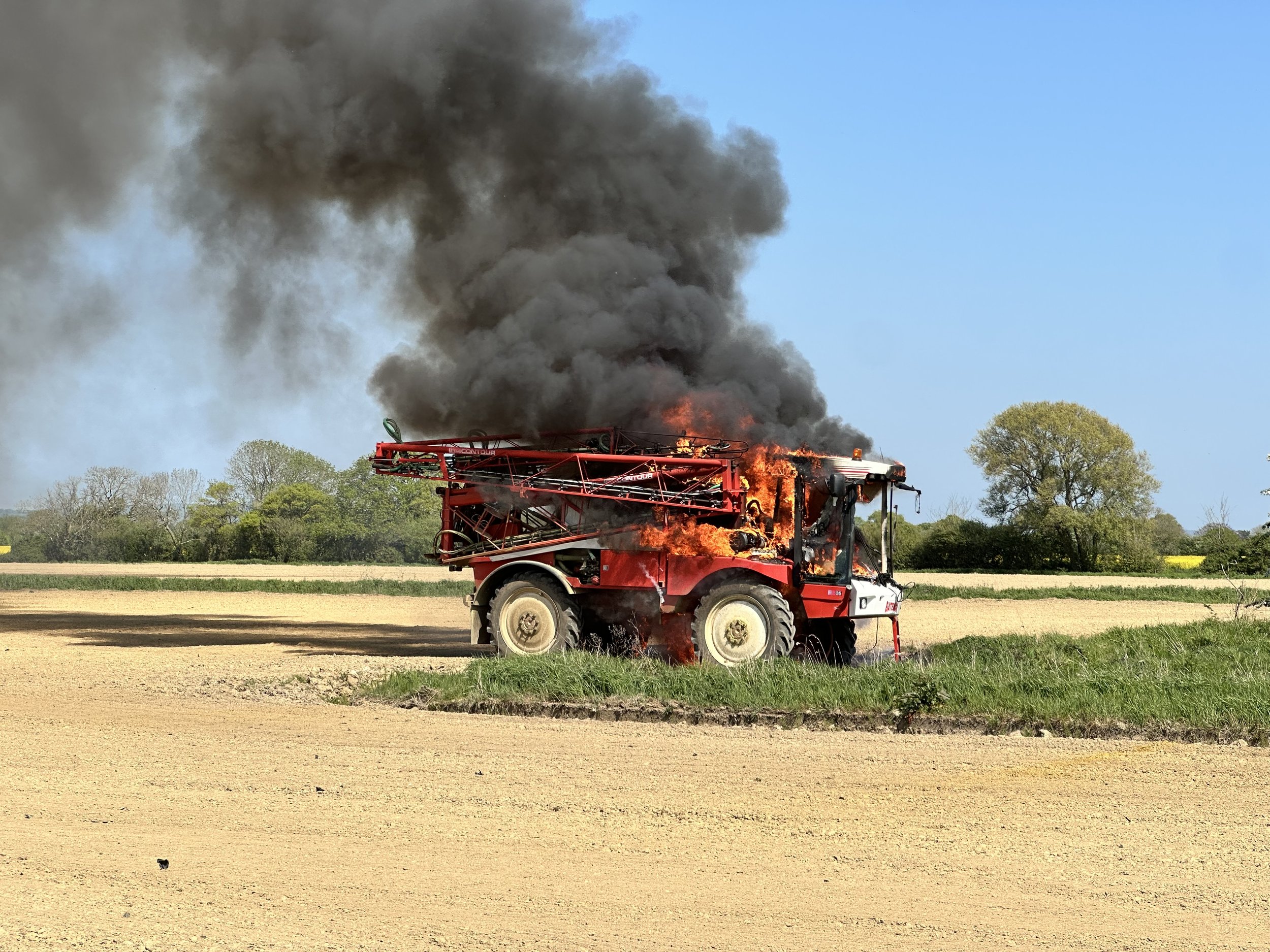 A photo of a crop sprayer on fire at Andrew Huxham's arable farm in West Sussex