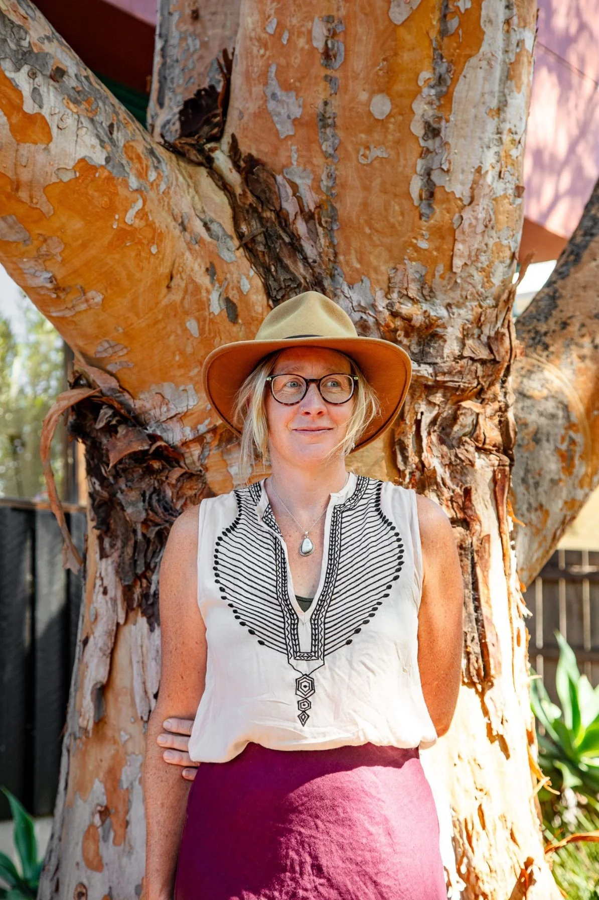 Artist Greta Hounslow stood in front of a large gum tree.