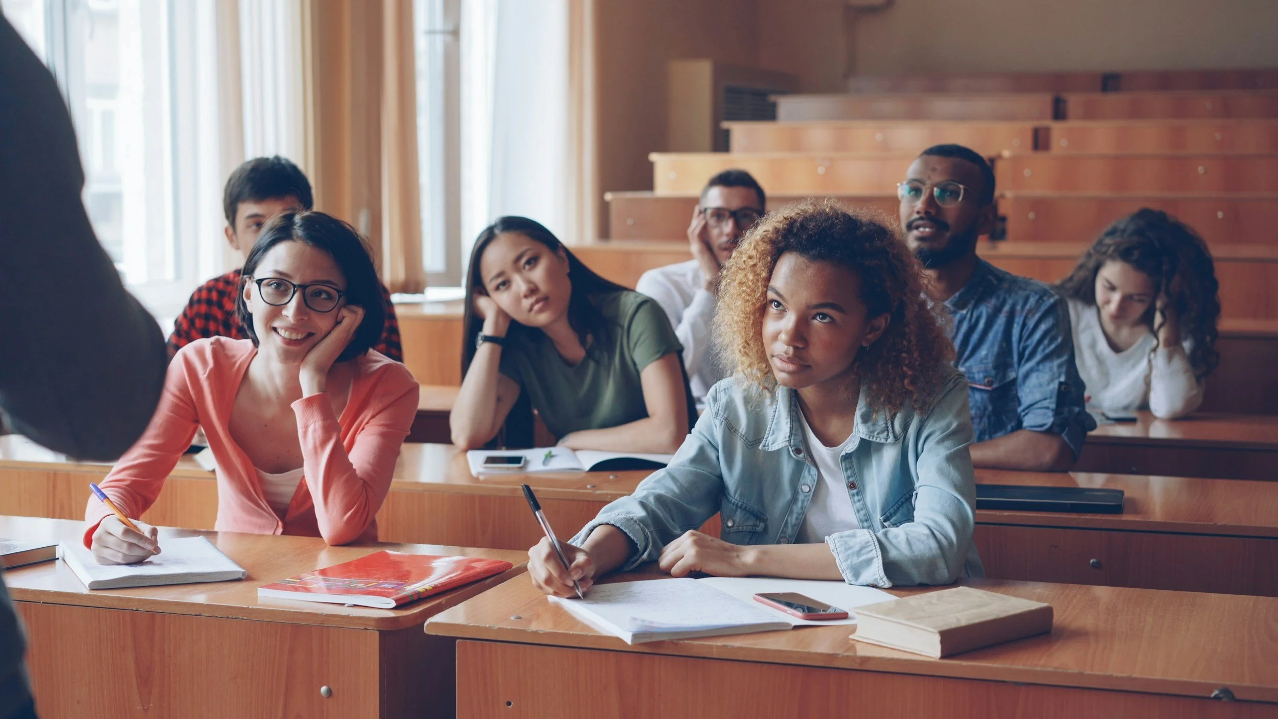 Small group of students look up at the group leader