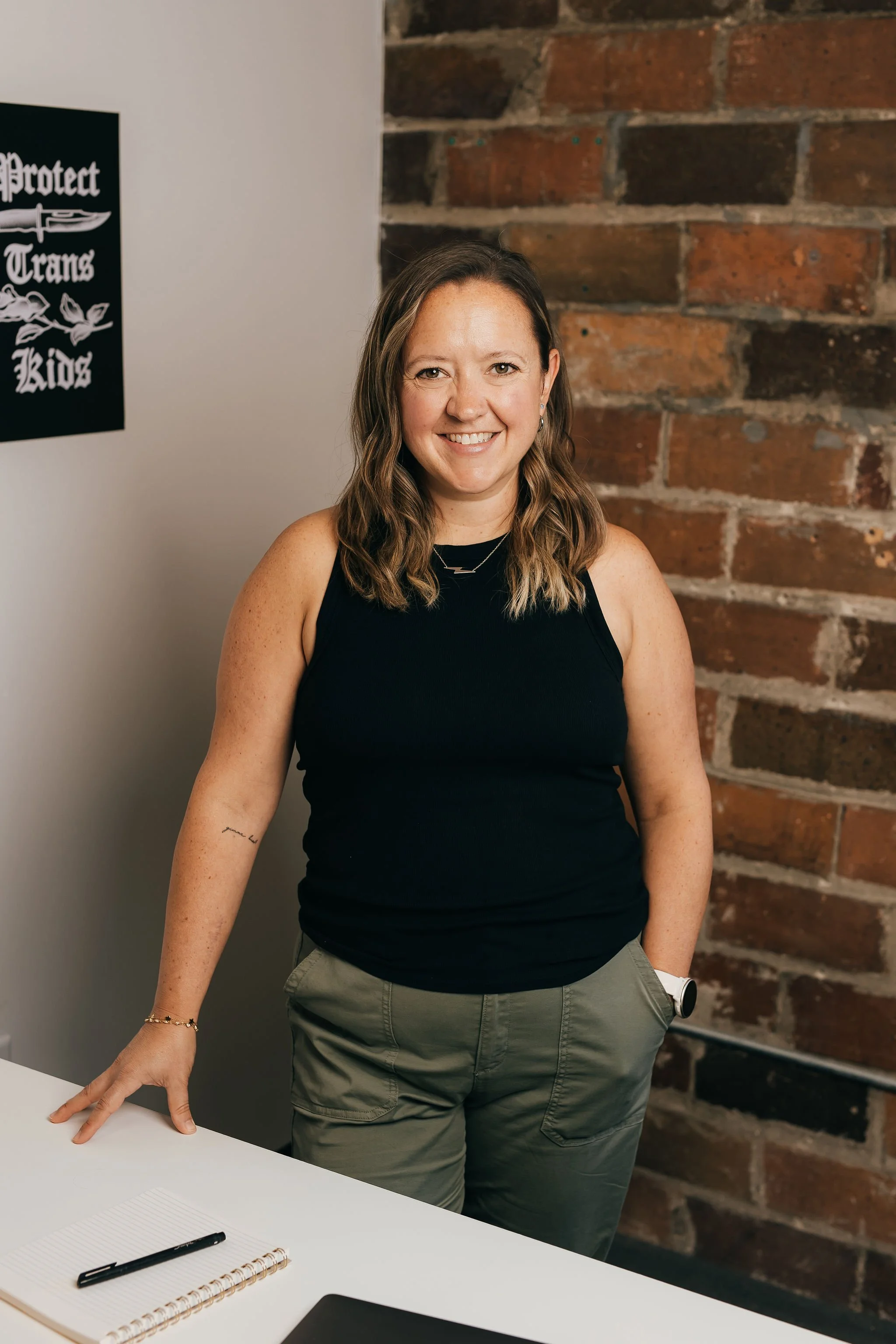 Trainer and consultant Kaleigh Cornelison looking directly into the camera and smiling.