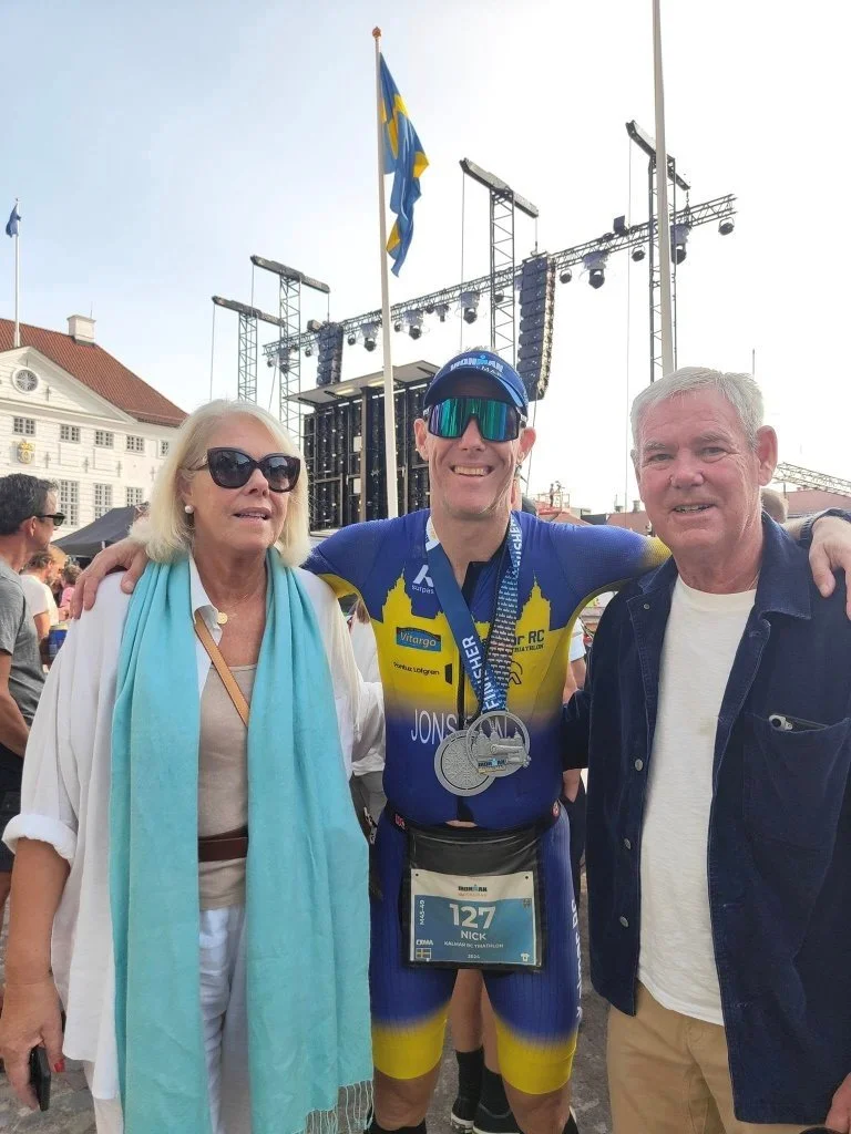 Nick Jonsson celebrating an IRONMAN finish line moment with family
