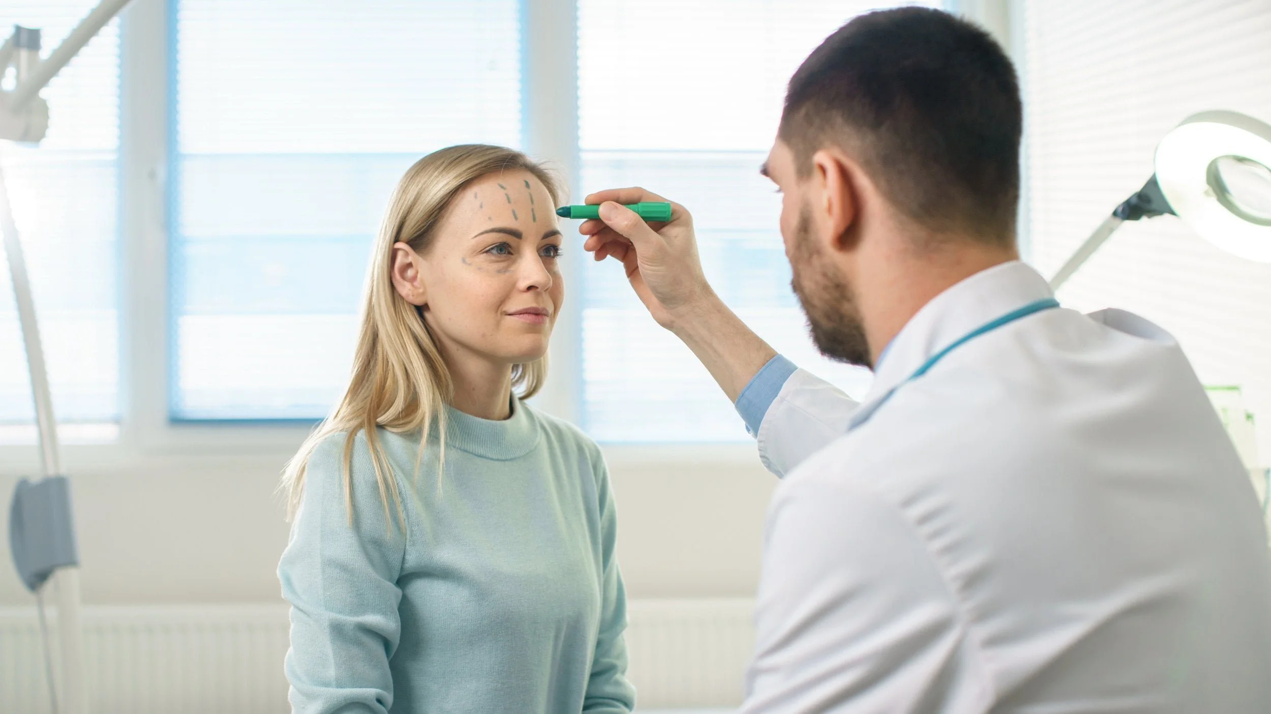 plastic surgeon marking face