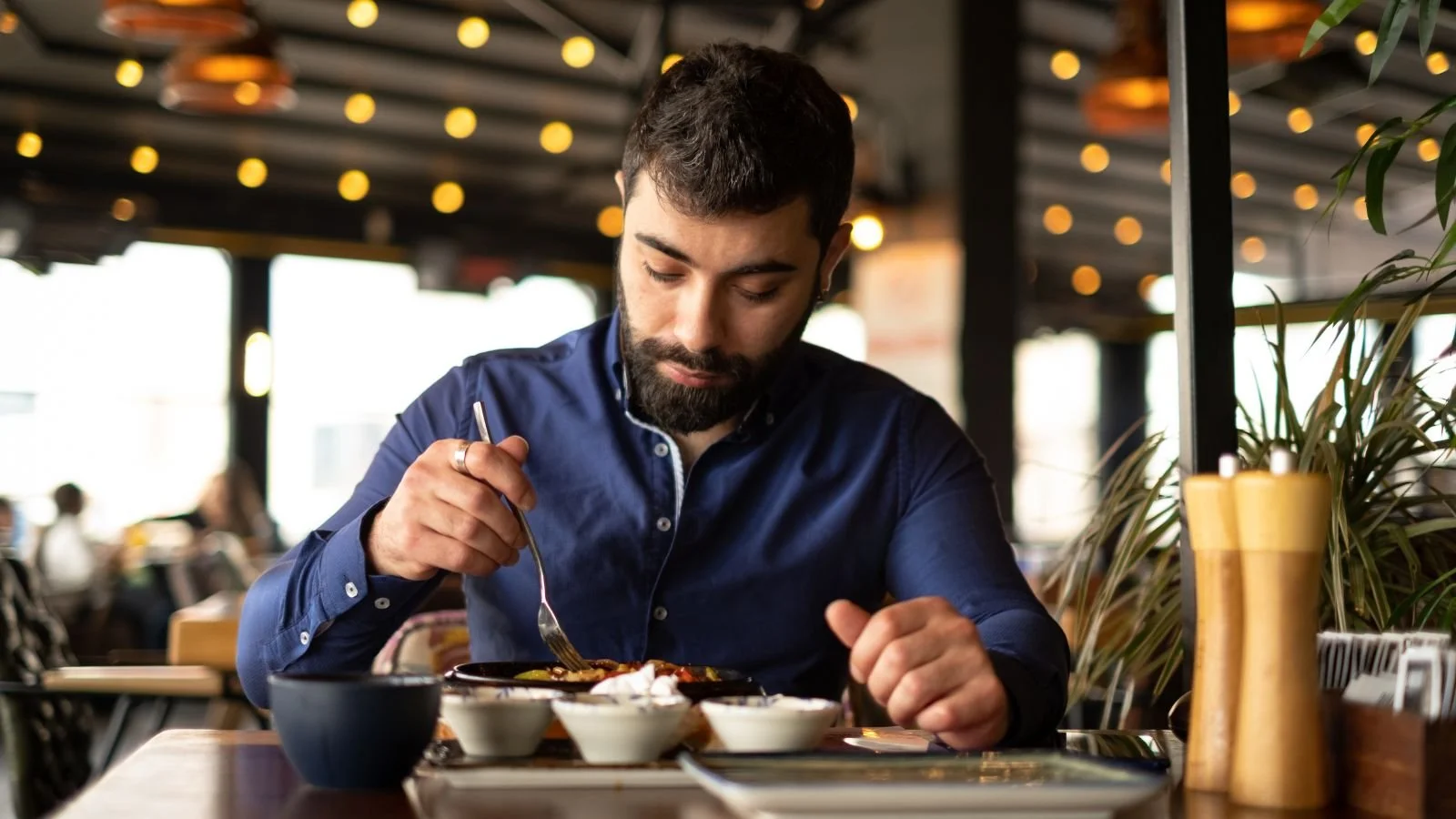 young man eating at a restaurant alone