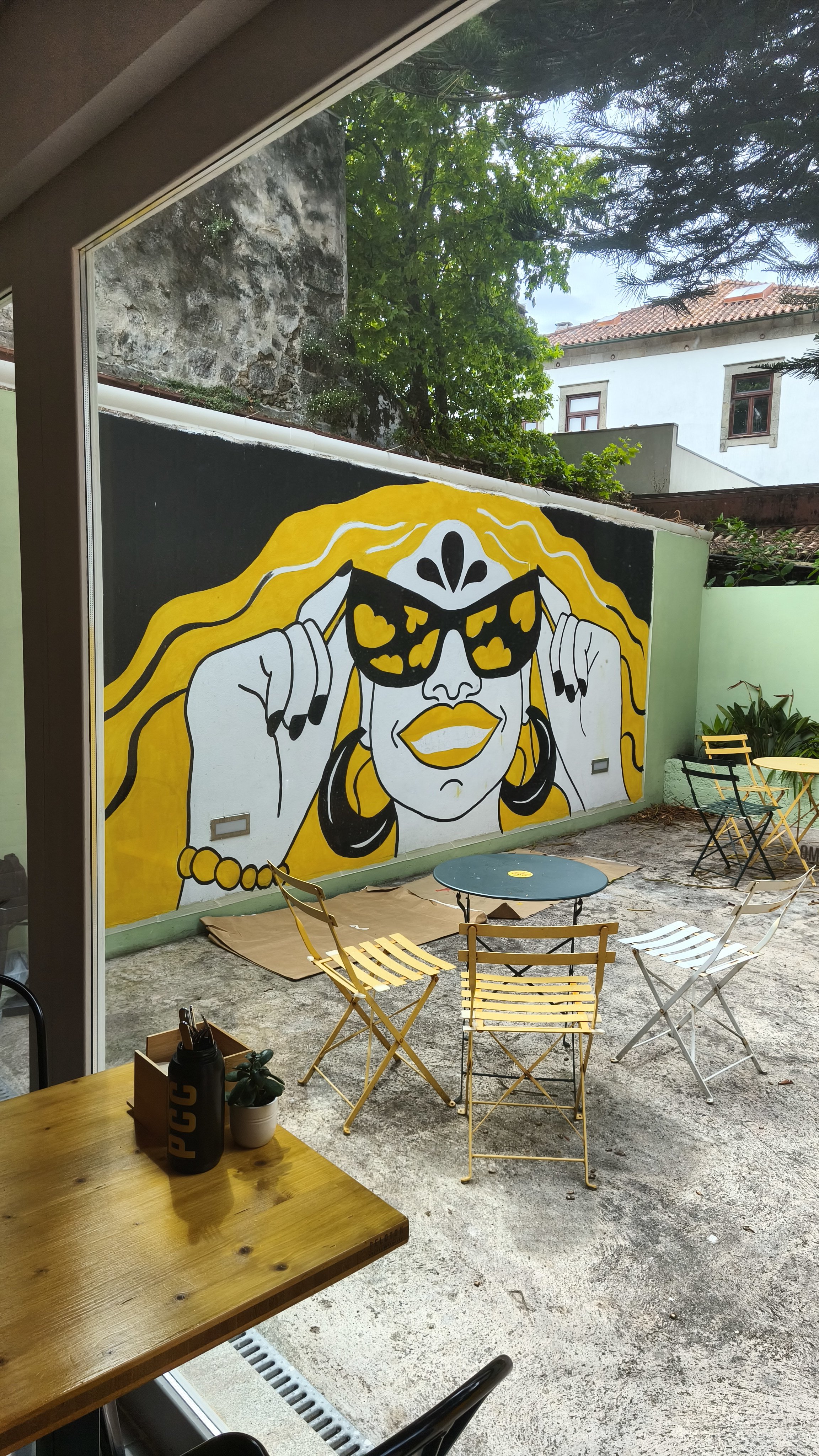 Wide angle view of the Peloton Café mural in progress