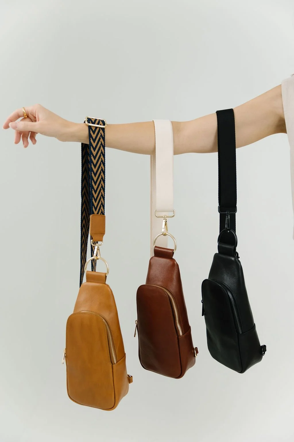 Lifestyle commercial product photography in St. George, Utah featuring modern handbags styled in a clean studio setting. This branding photoshoot showcases fashion accessories through professional product photography created for clothing brands, acce