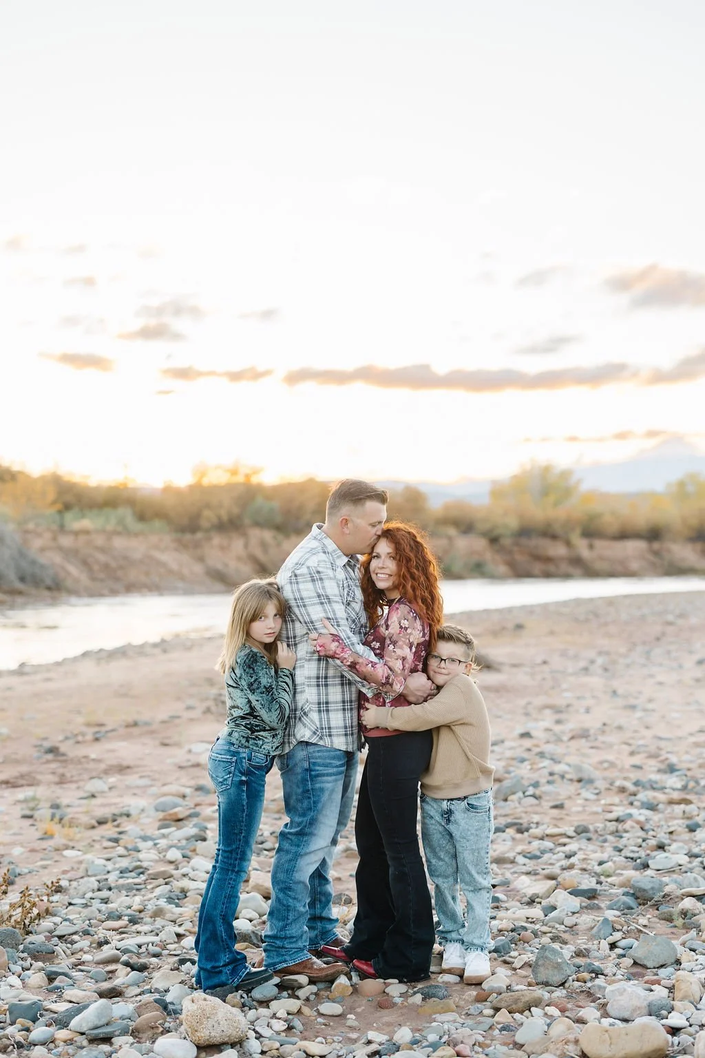 Lifestyle family photography capturing a mother and her children sharing a sweet moment outdoors in Southern Utah. This St. George family photoshoot focuses on genuine connection, natural emotion, and timeless images that preserve the special bond be
