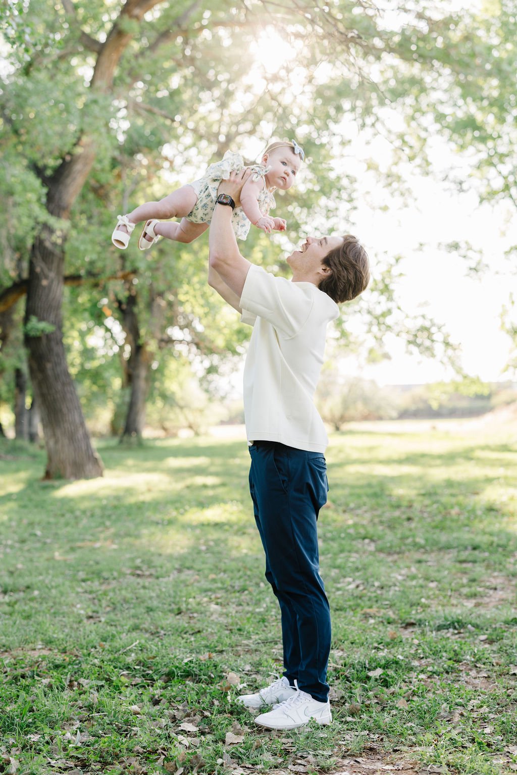 Lifestyle family photography capturing a joyful father and child sharing a playful moment outdoors. This St. George family photoshoot focuses on genuine connection, natural emotion, and the sweet everyday moments between parents and children that des