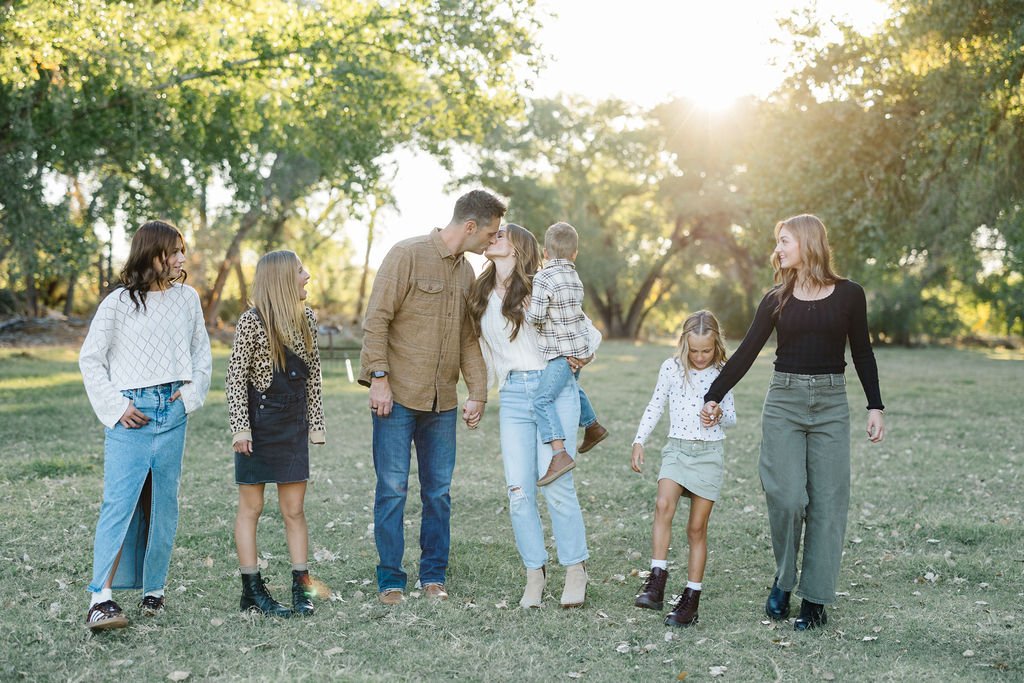 Lifestyle family photography capturing genuine connection and natural movement during a relaxed outdoor session. This St. George family photoshoot creates timeless images filled with laughter, personality, and the authentic relationships between pare