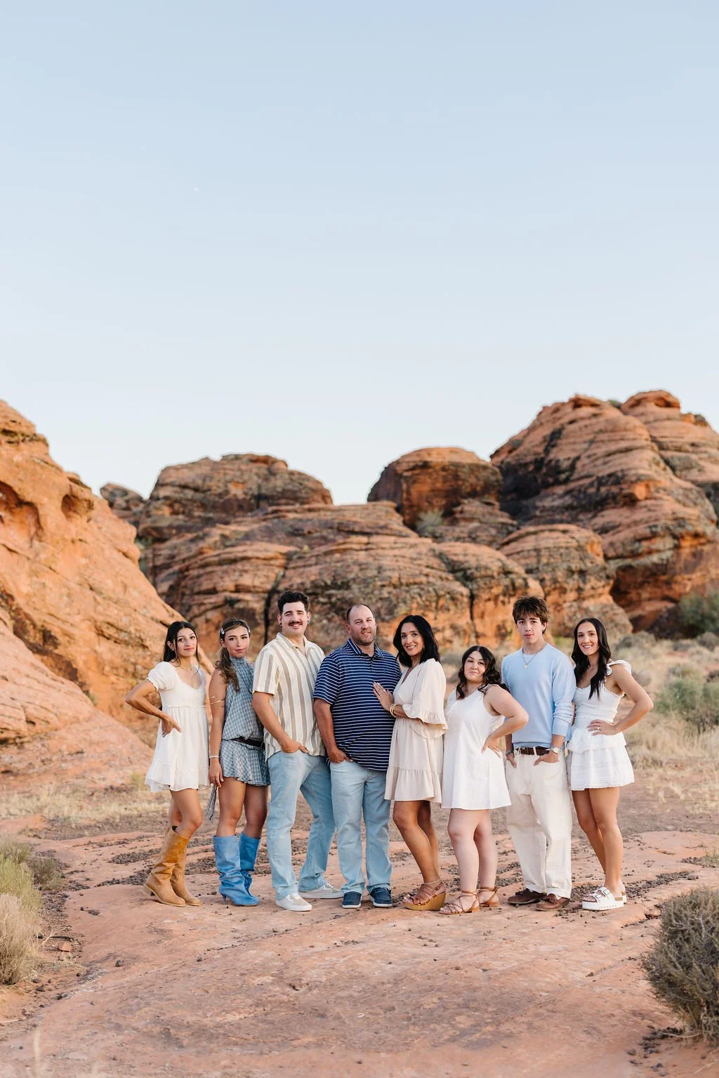 Extended family photography capturing multiple generations together against the red rock landscapes of Southern Utah. This St. George extended family photoshoot celebrates genuine connection and creates timeless images for large families, reunions, a