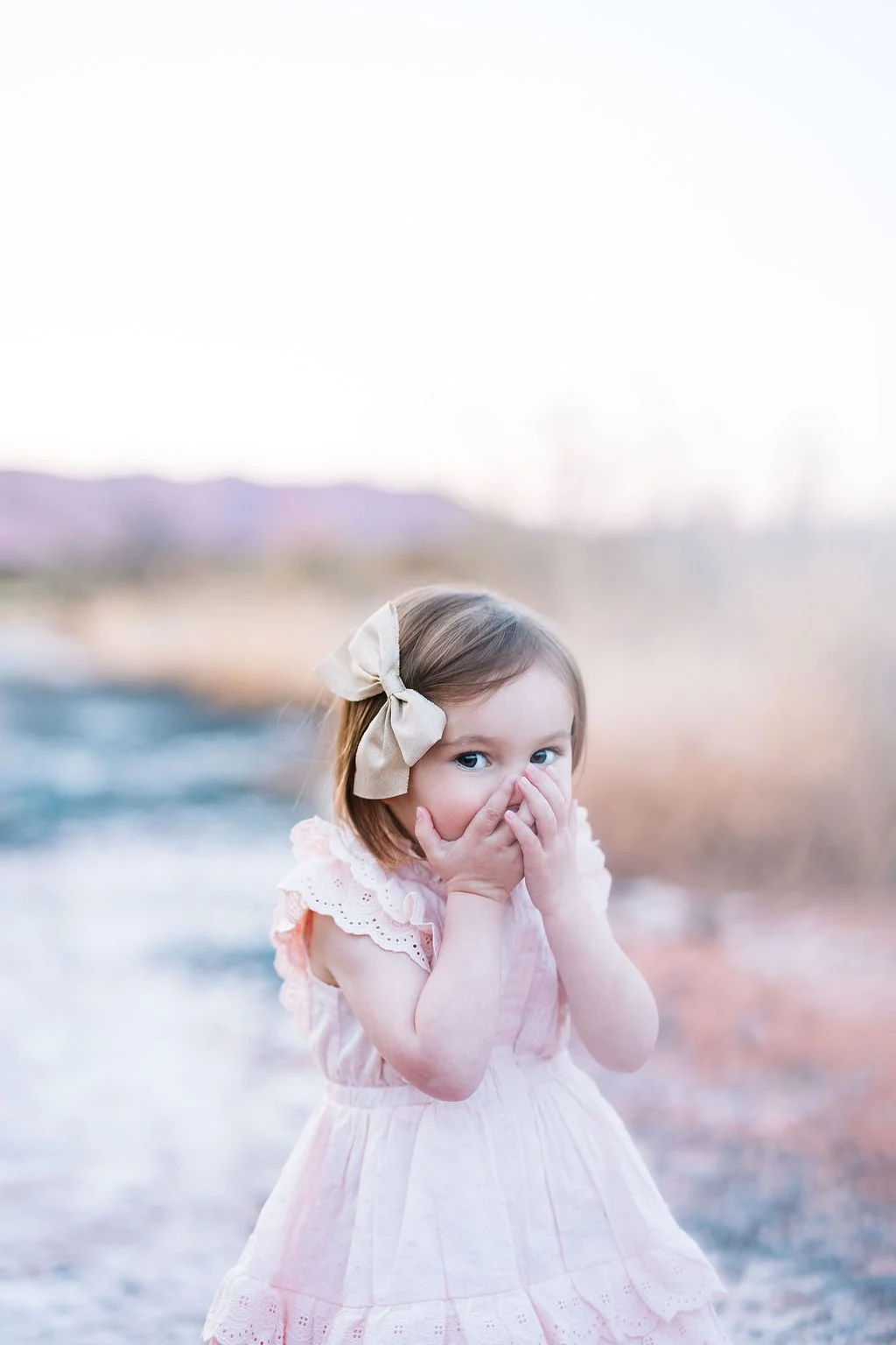 Child portrait photography capturing a playful, candid moment filled with personality and natural emotion. This St. George children’s photography session creates timeless images that celebrate childhood, imagination, and the sweet little moments pare