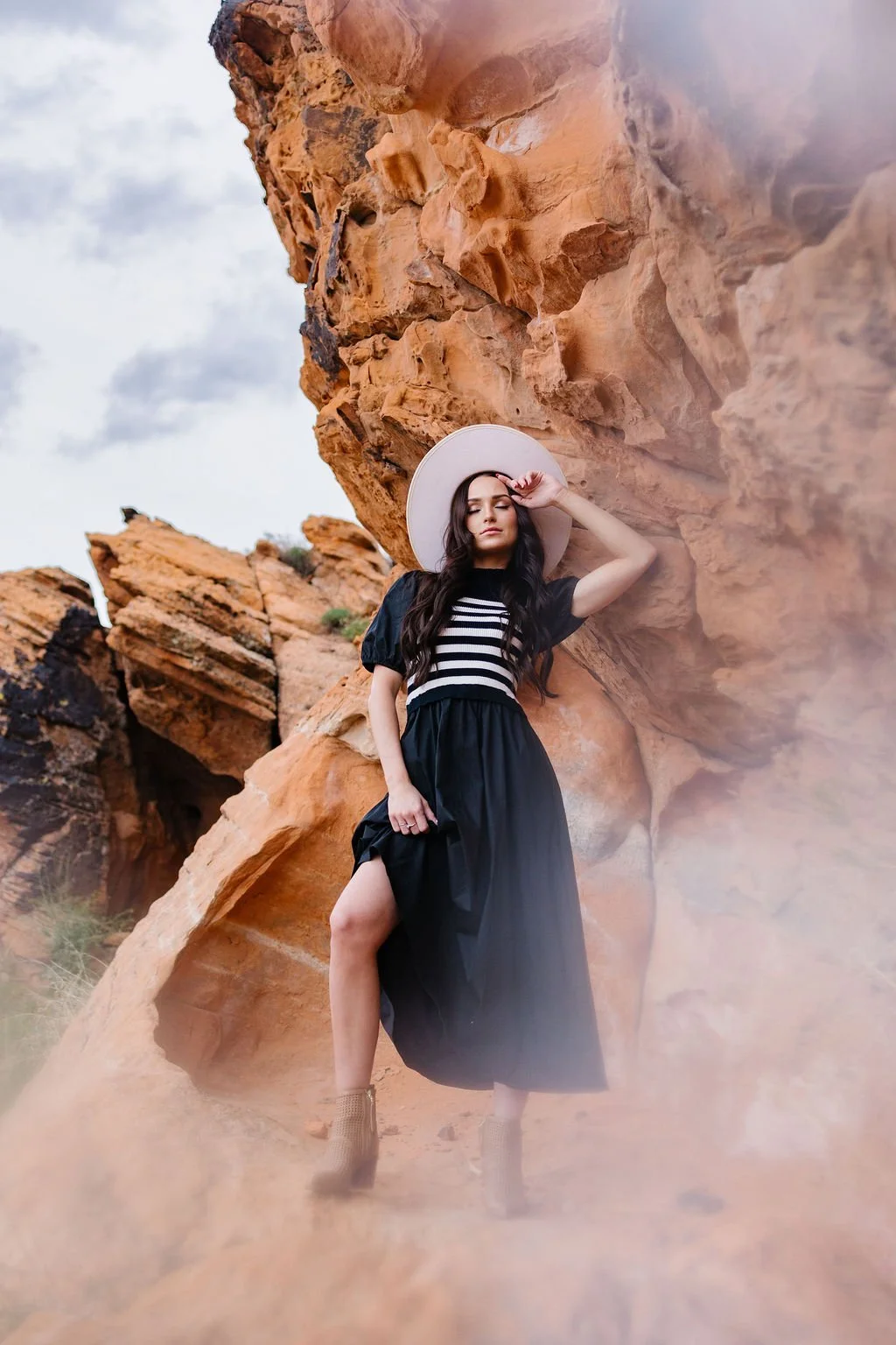 High fashion editorial photography in Southern Utah featuring a dramatic clothing campaign photographed against the red rock desert landscape. This fashion photoshoot blends bold styling, movement, and creative direction to create striking editorial 