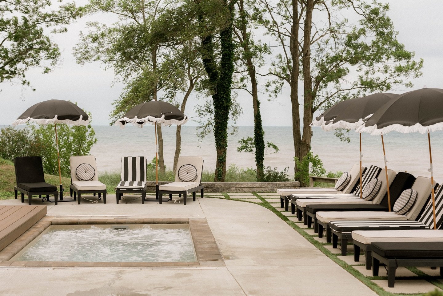 Summer&rsquo;s not here yet in Michigan&hellip; but we sure are thinking about it.

We designed this outdoor lounge area to feel like a natural extension of the home&rsquo;s architecture - carrying those soft arches into a grounded, textural landscap