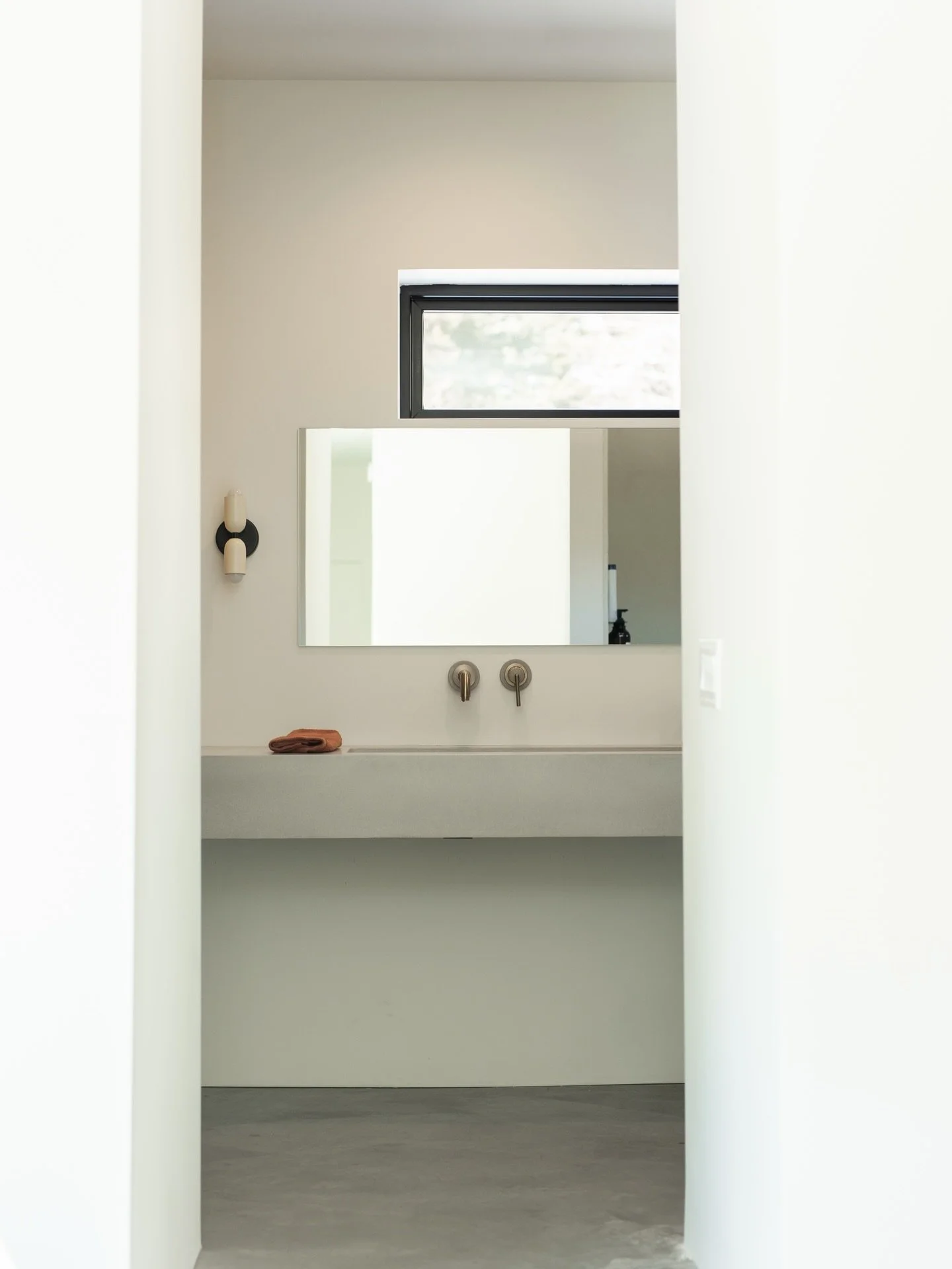 An open concept bathroom off the primary. Clean, warm, and just a little edge.
