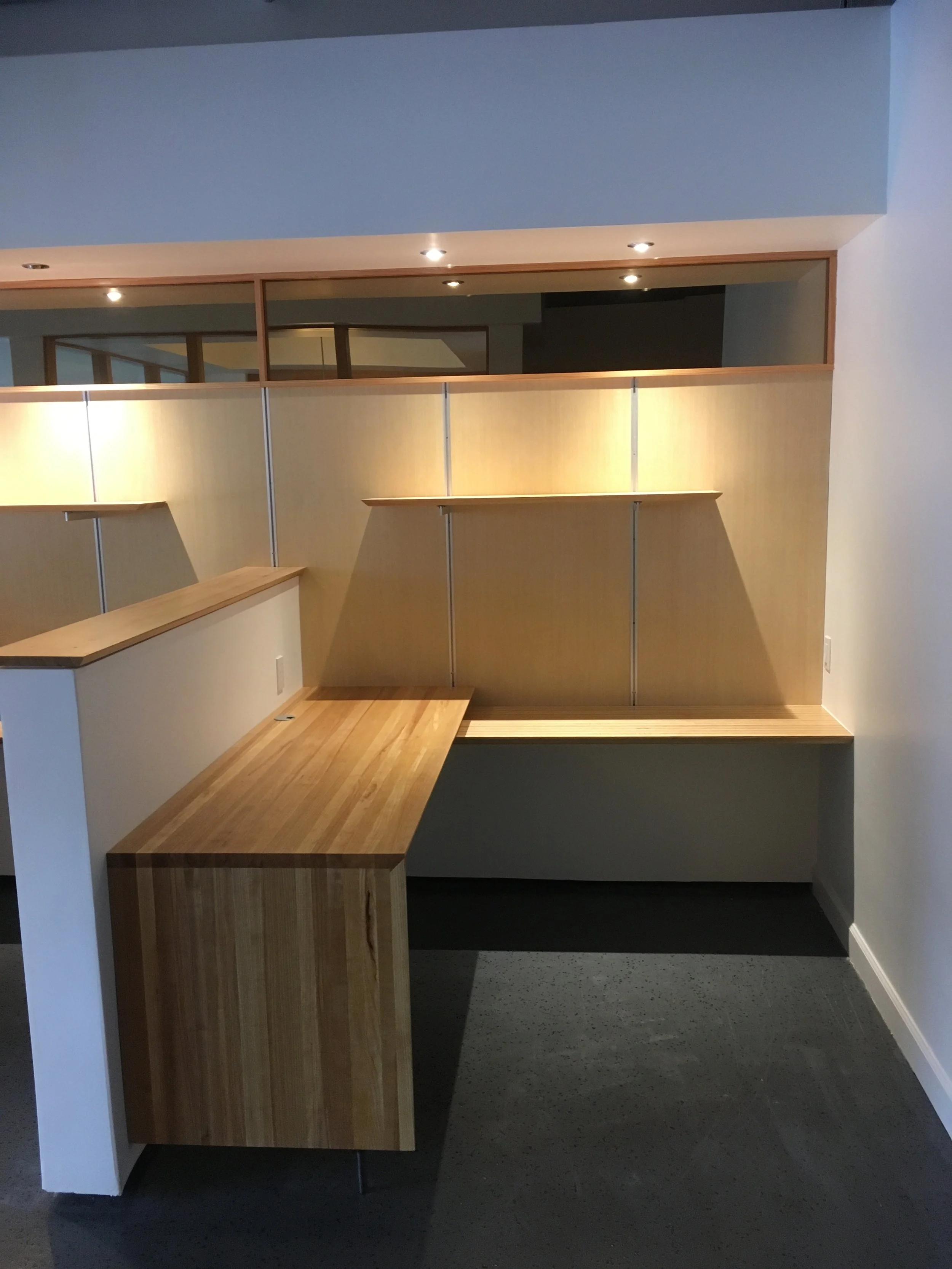 Workstation view two with wood capped pony wall, mirror, and soffit with downlights