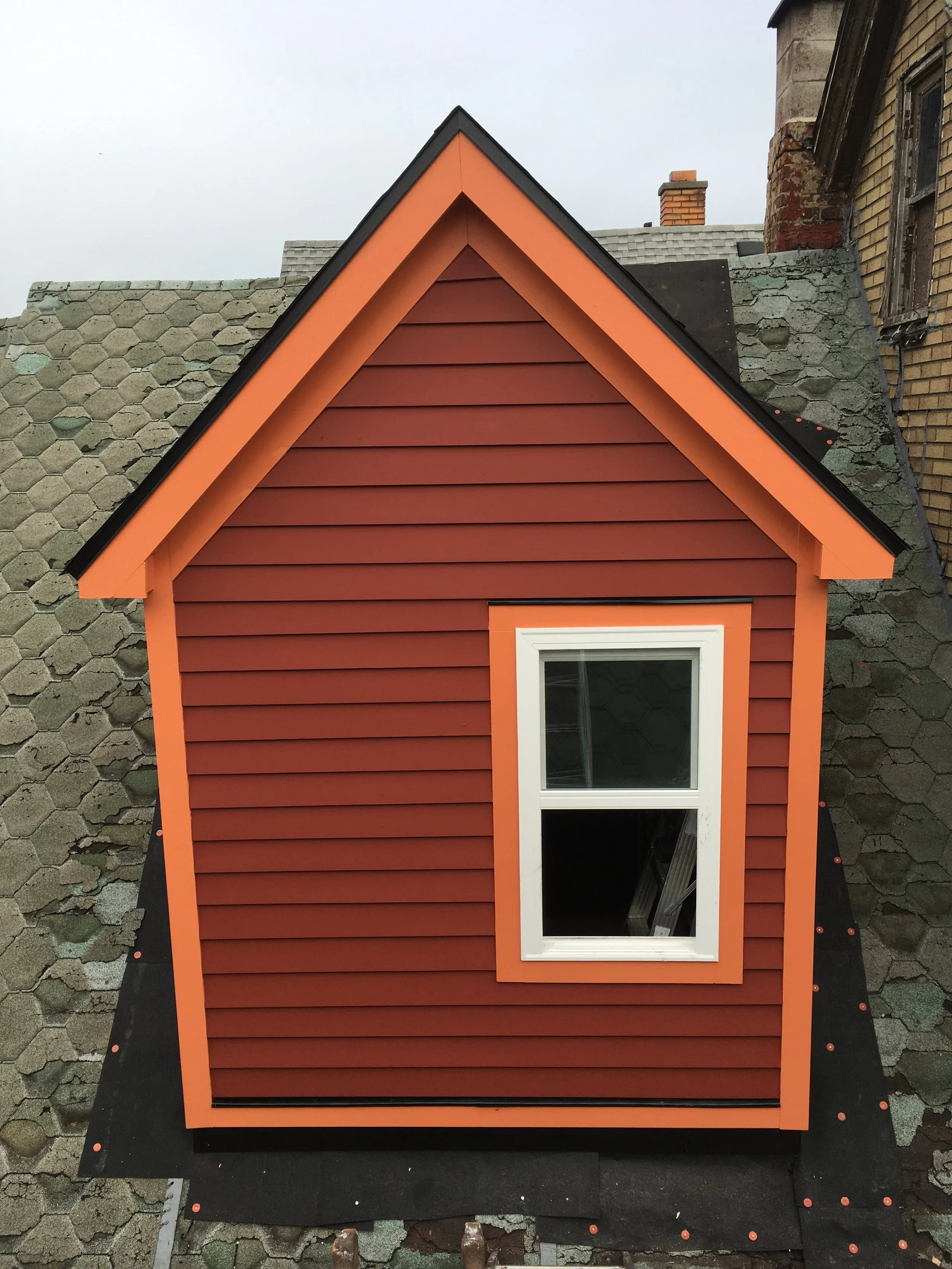 Dormer for bathroom cut into roof, framed, sided, painted and shingled