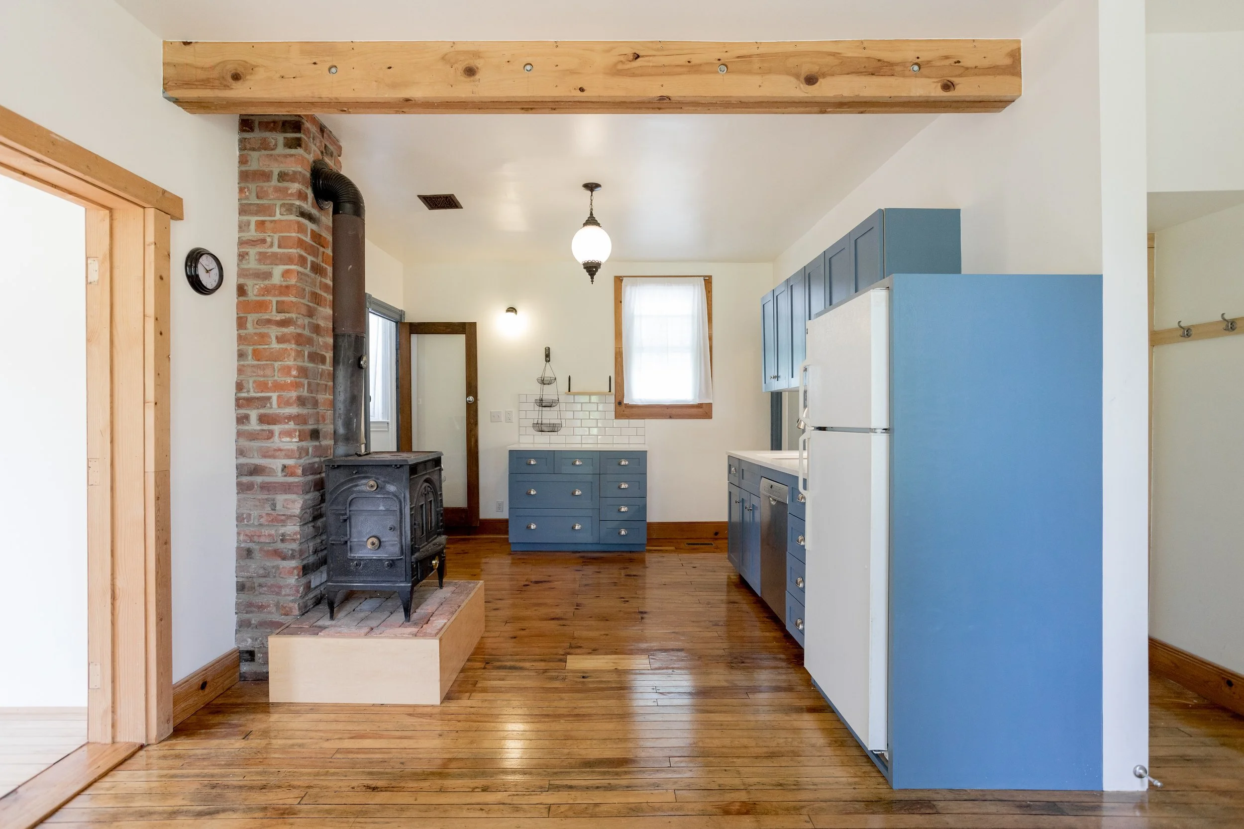Kitchen build with header, chimney, site built cabinets, tile and refinished floors