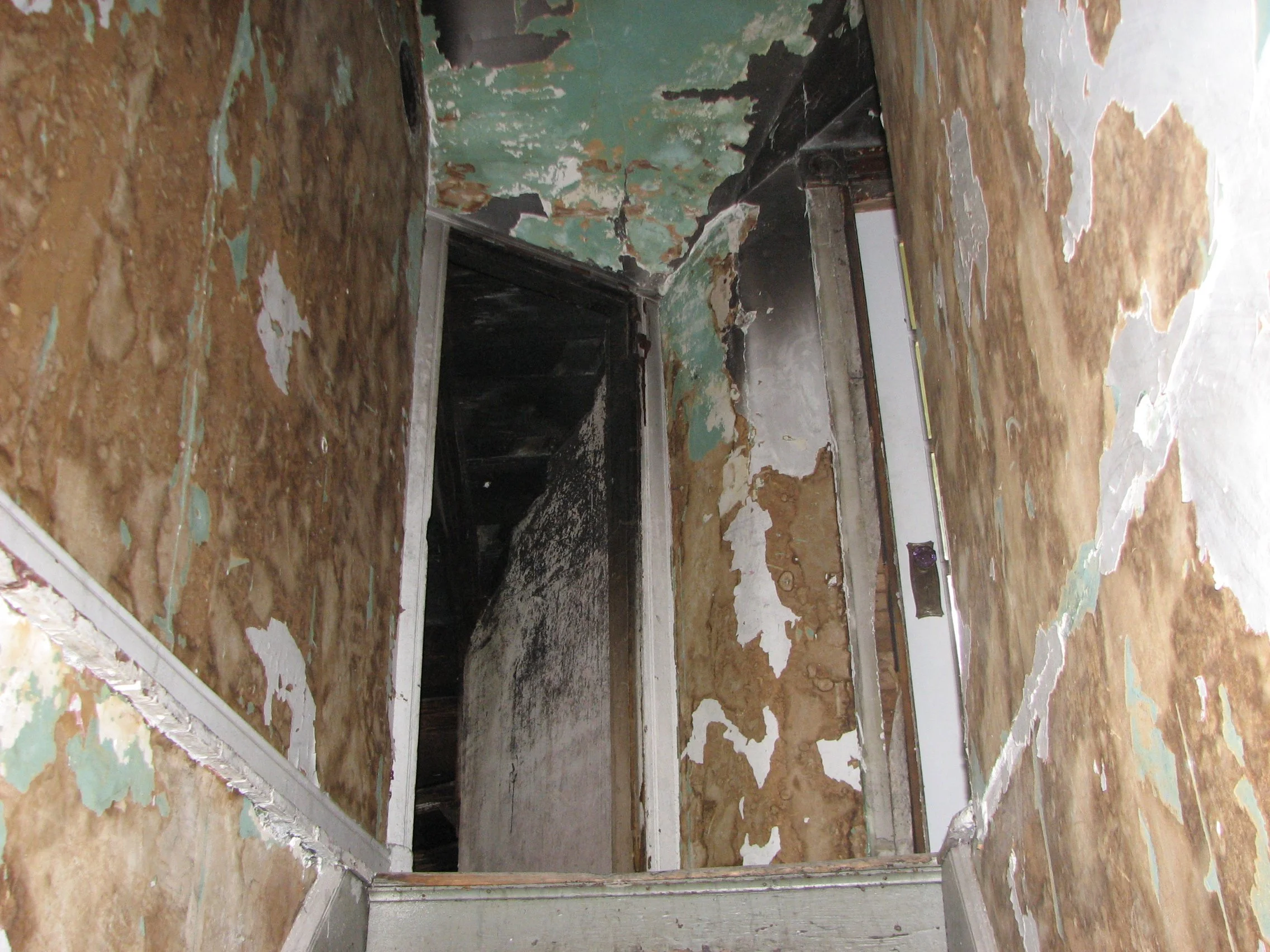 Charred hallway and attic and will become bedroom on left