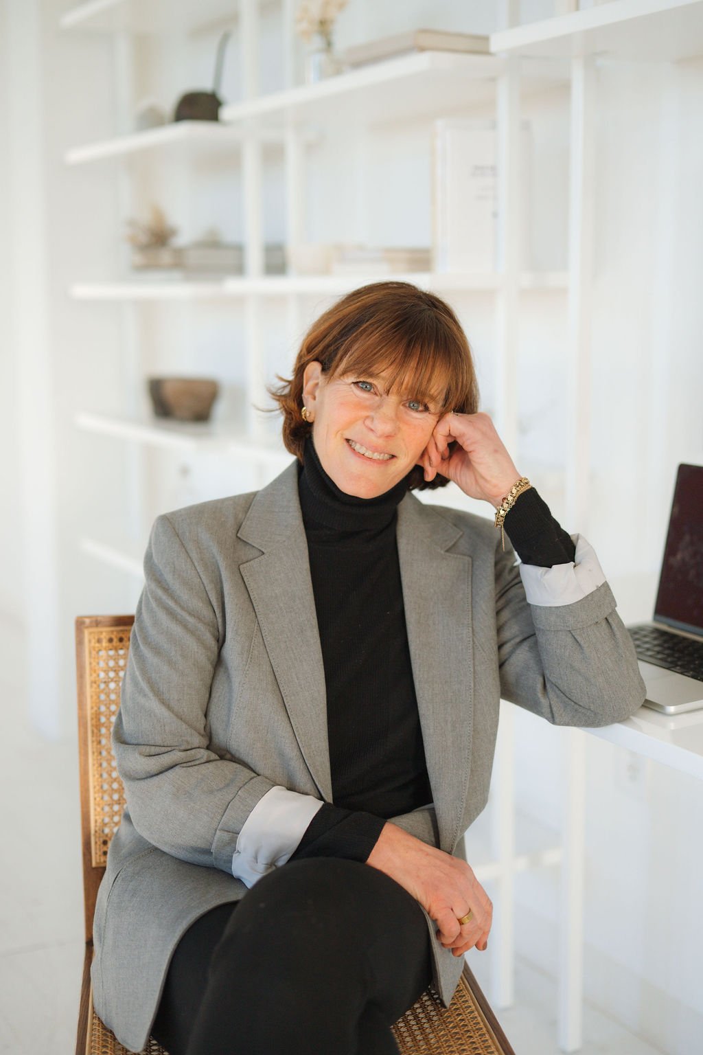 Headshot of smiling female tutor with short blonde hair wearing a lanyard.