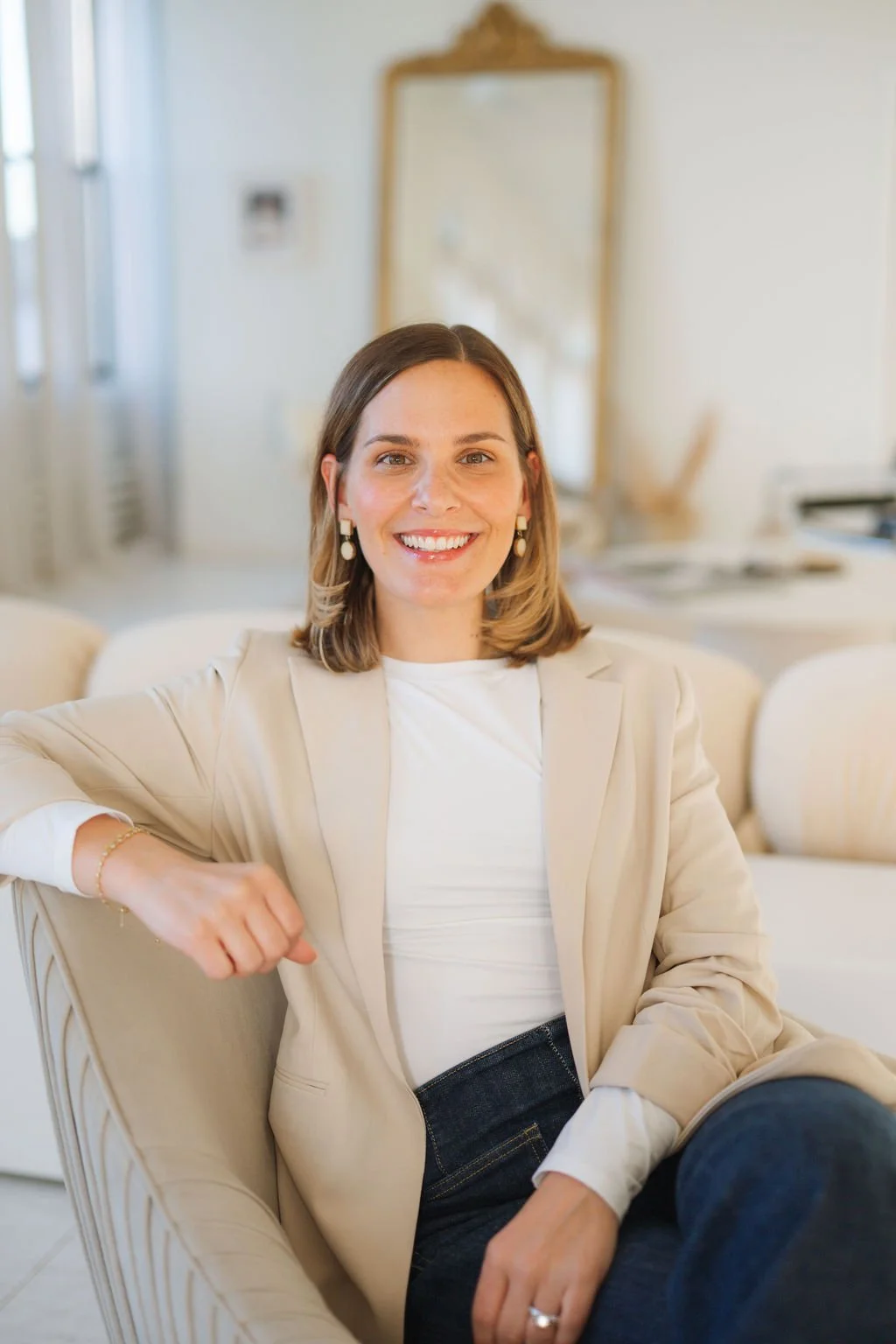 Headshot of smiling female tutor with short blonde hair wearing a lanyard.