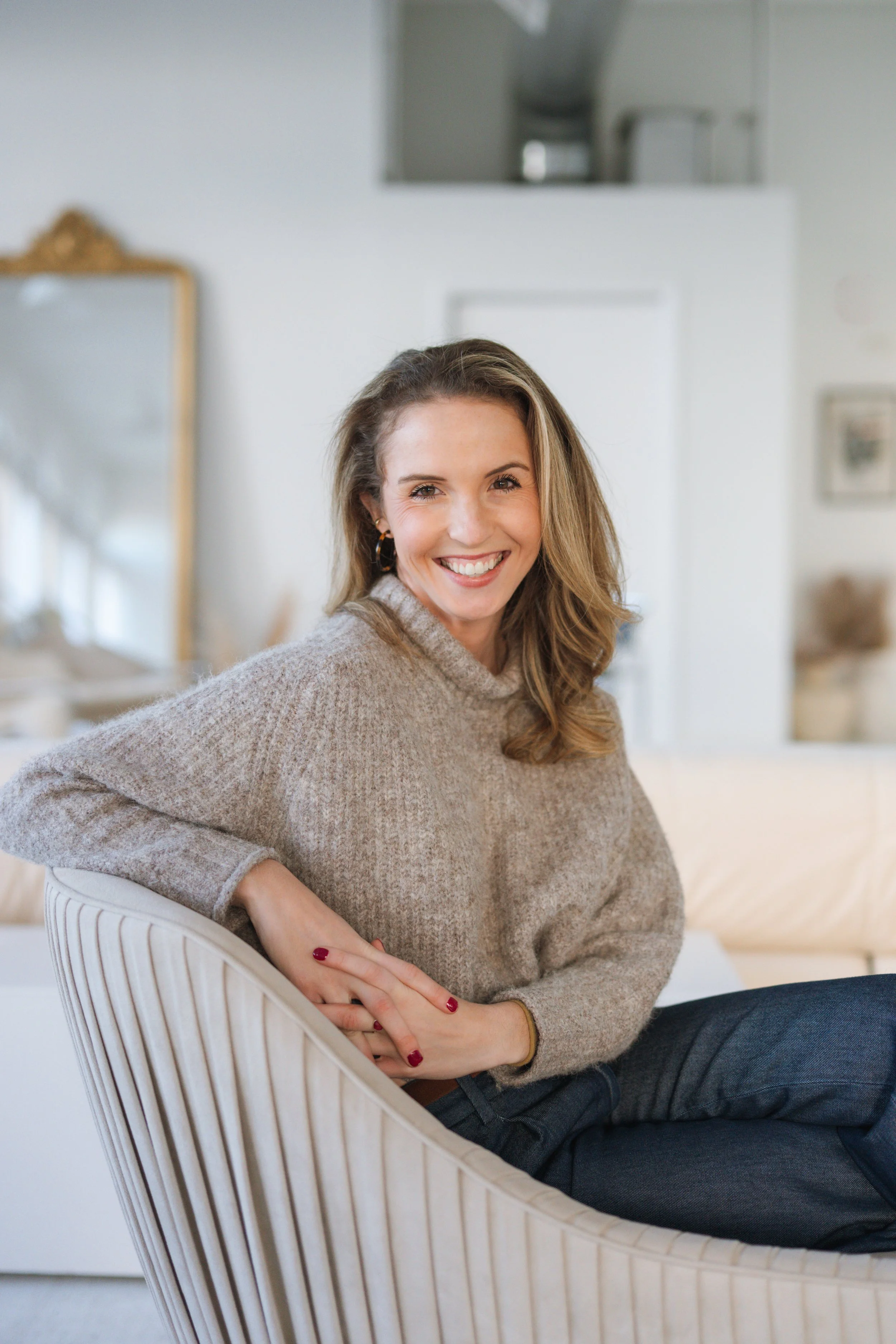 Headshot of smiling female tutor with short blonde hair wearing a lanyard.